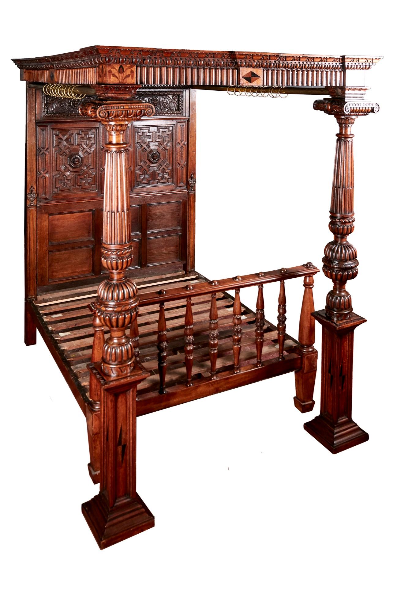 Outstanding antique Victorian carved oak and marquetry inlaid 4-poster bed, the cornice having lovely carved decoration with marquetry inlay. Finely carved oak back panels with carved central figure and 6 moulded oak panels below. Oak splats to the