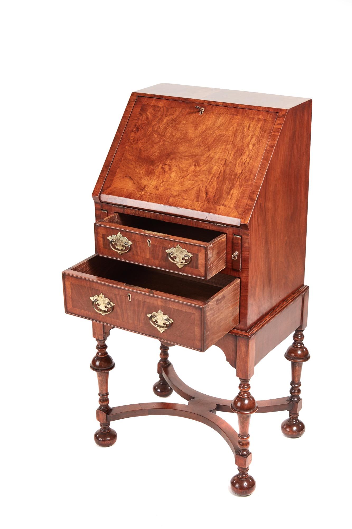 Outstanding antique William & Mary style figured walnut bureau. The fall and drawers all boast crossbanding on beautiful walnut veneers. The fall opens to reveal two drawers and pigeon holes and two front drawers with original brass handles. It