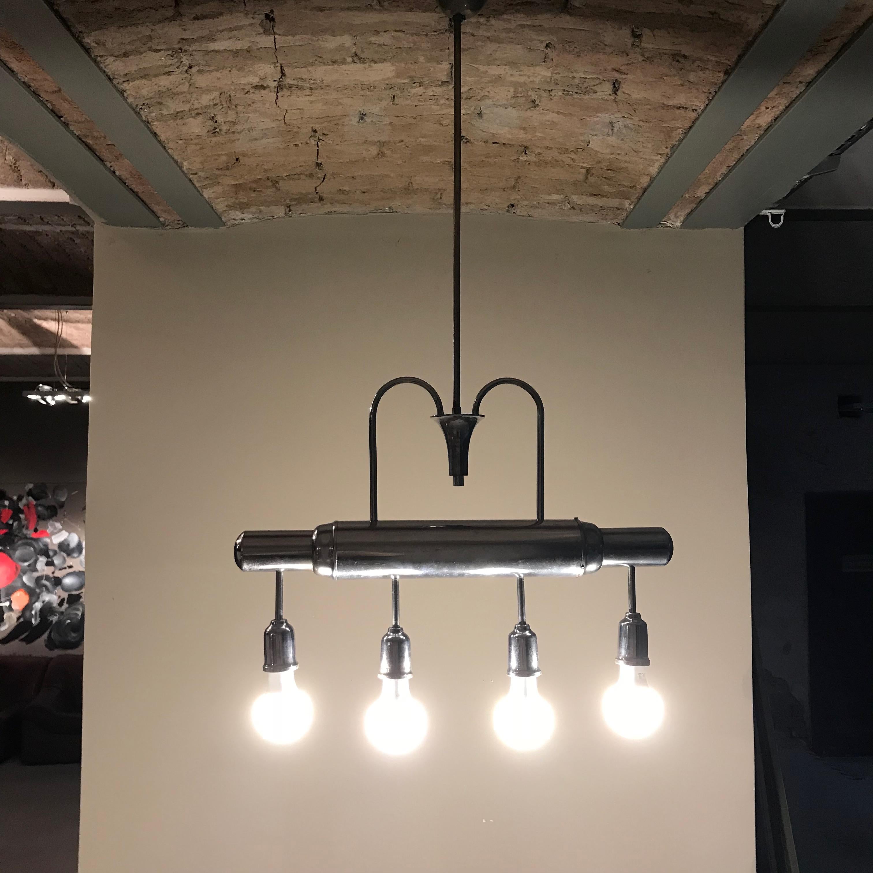 Art Deco pendant lamp handmade in the 1930s. The lamp is made in form of the streamlined locomotive of the time.
Newly rewired, fully working and tested condition - four porcelain Edison E27 sockets. The light works on 110V - 240V.
Very good
