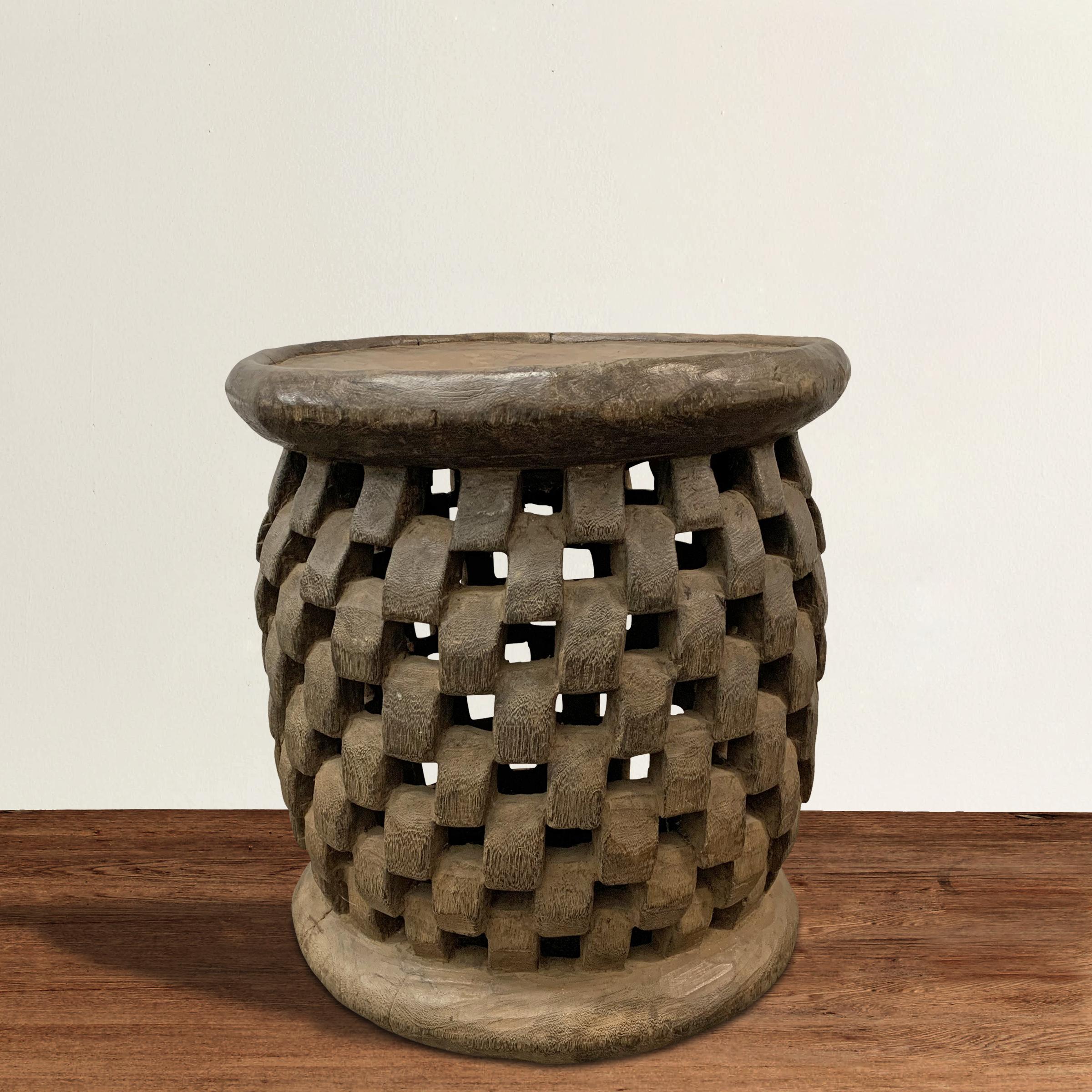 An outstanding early 20th century Bamileke stool hand carved of one piece of wood with a mesmerizing 