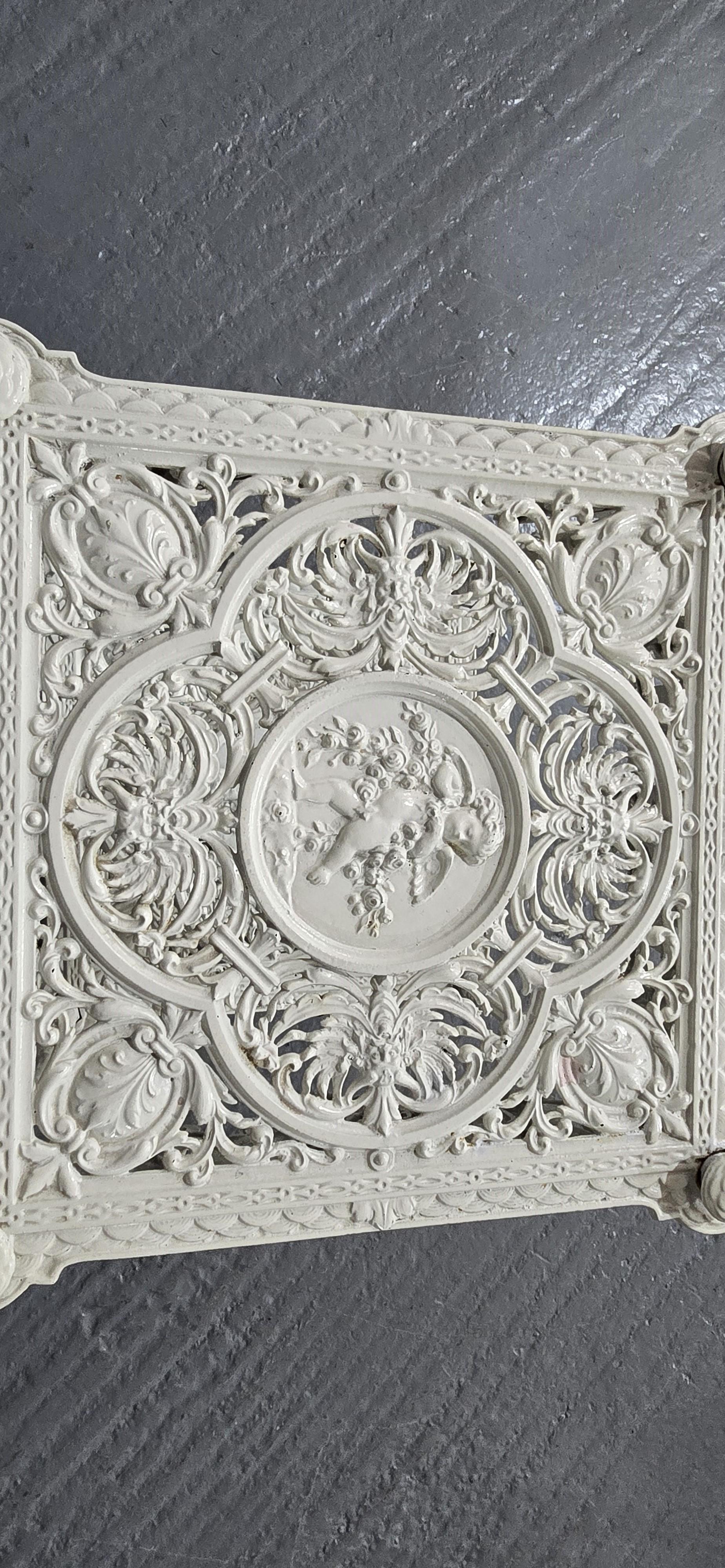 An outstanding cast iron jardinere three tier stand, with super and very crisp castings of cherubs, masks, dolphin feet and scrolls, painted white, and in escellent condition.

33.5