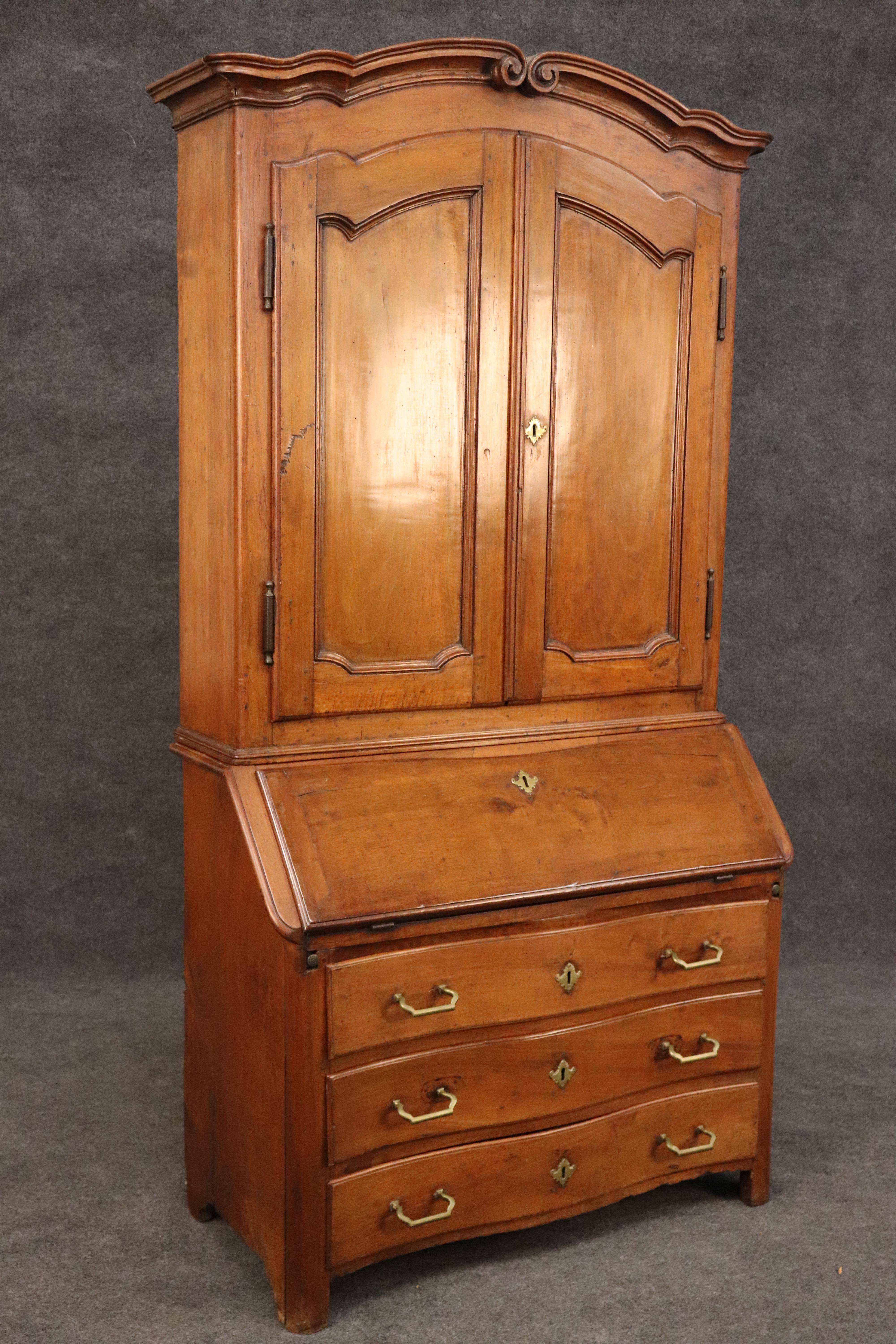 This is a superb, Period French country Louis XV secretary desk from the Normandy region of France. The piece is made of solid walnut with brass hardware. The piece shows signs of age and use and wormholes which collectors of antique know are normal