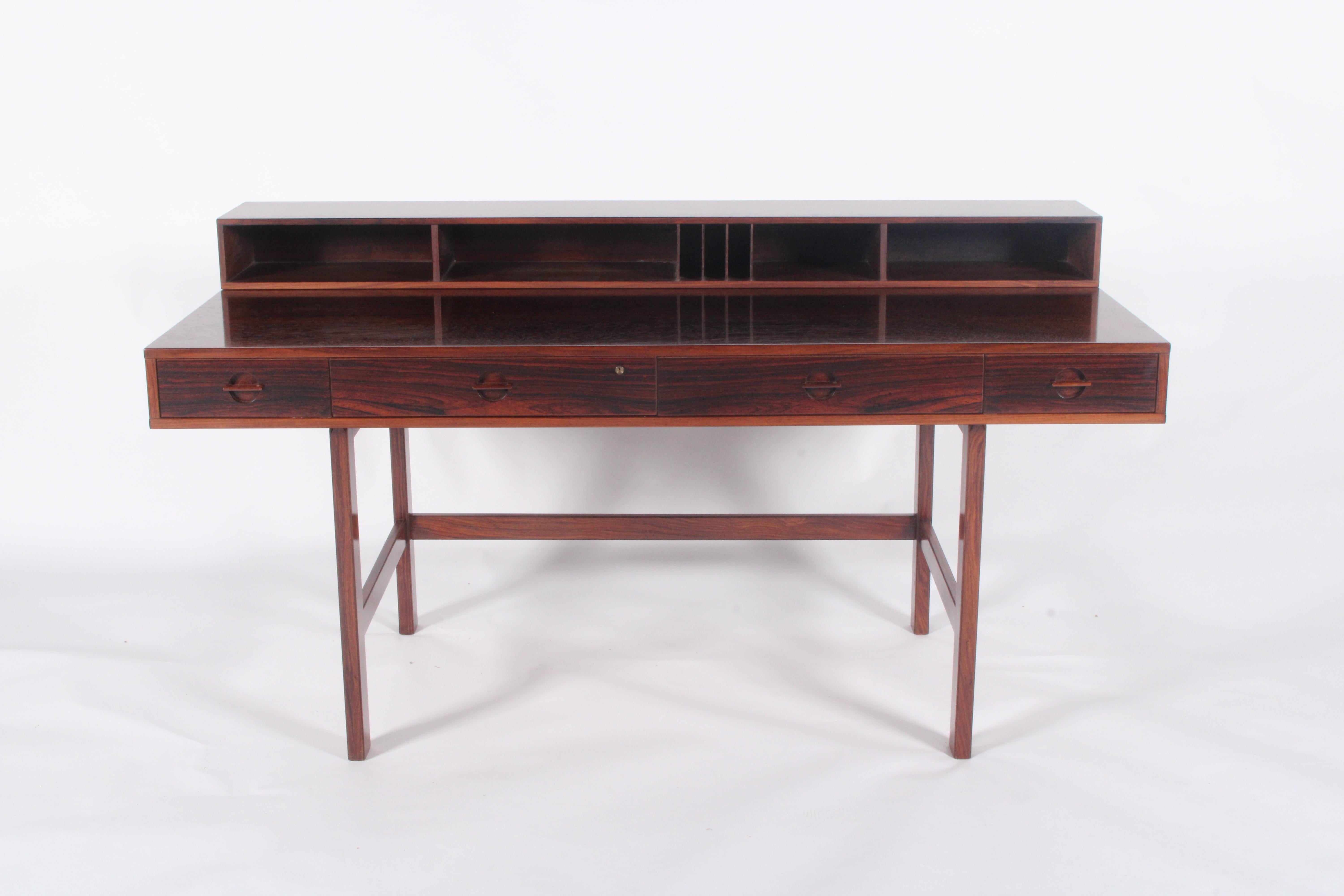 This Danish mid-century modern desk, designed by Peter Løvig  Nielsen and dated 1973, is a stunning example of craftsmanship and functionality. Made from rich, dark rosewood, it features a sleek, minimalist design characteristic of Scandinavian