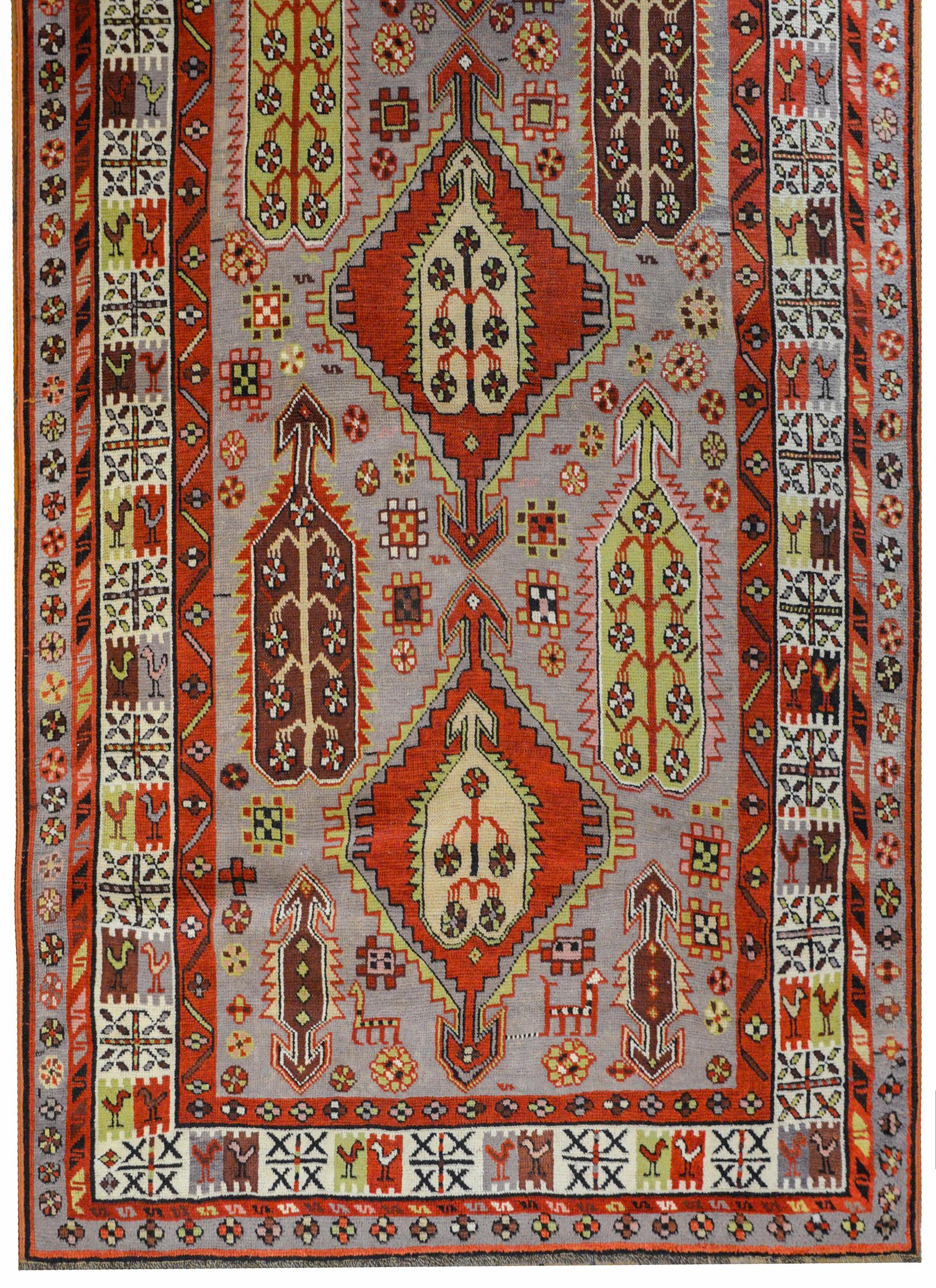 An outstanding early 20th century Karebak rug with a beautiful all-over large-scale abstract paisley pattern woven in coral, pale green, pink, white, and black, amidst a field of stylized flowers woven in similar colors, all on a pale lavender