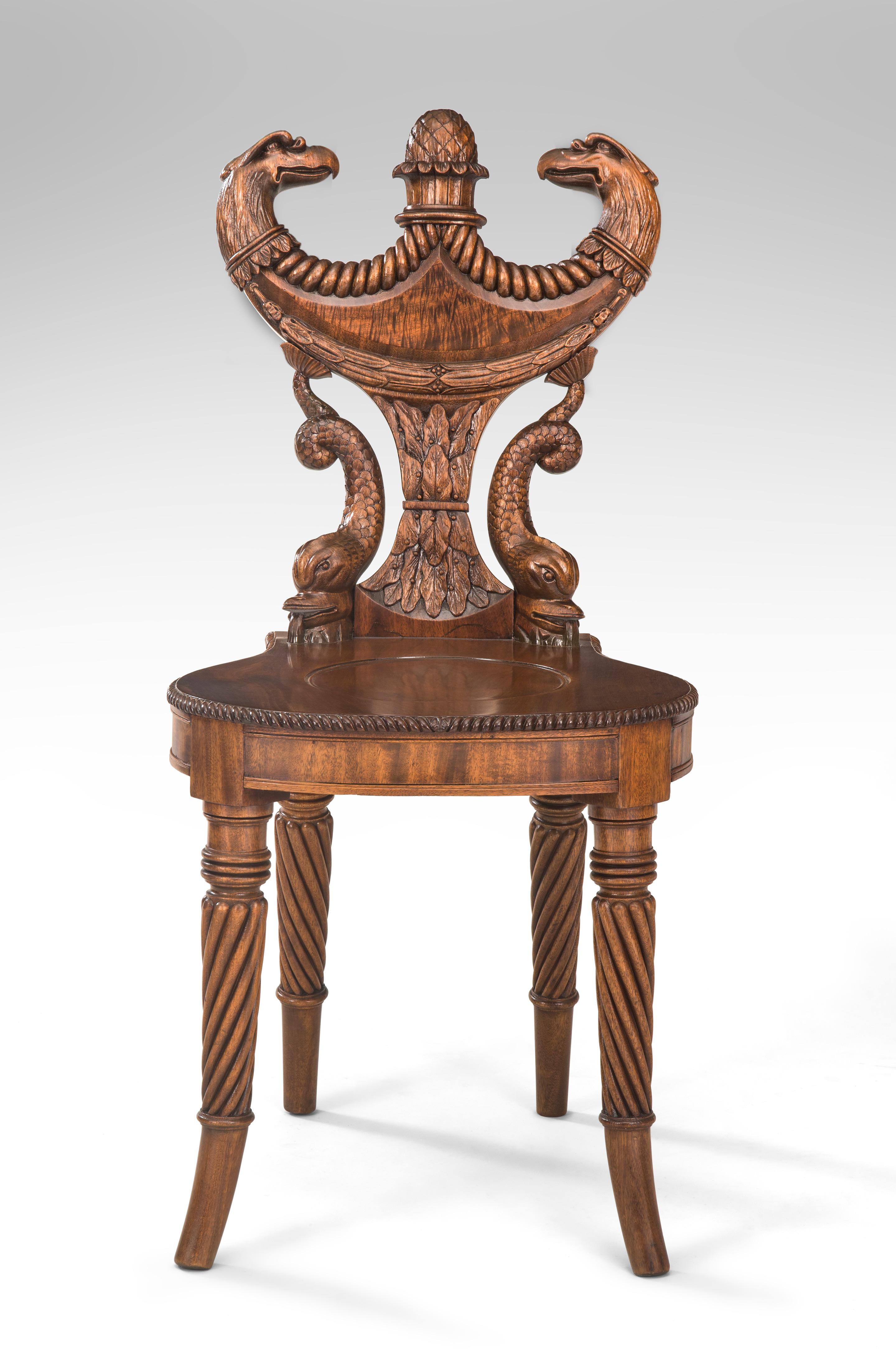 Outstanding English Regency mahogany hall chair
Late 18th or early 19th century
A highly original hall chair of ingenious design and superb carving, a rare and exceptional chair. The double headed eagle shield back supported by flanking dolphins,