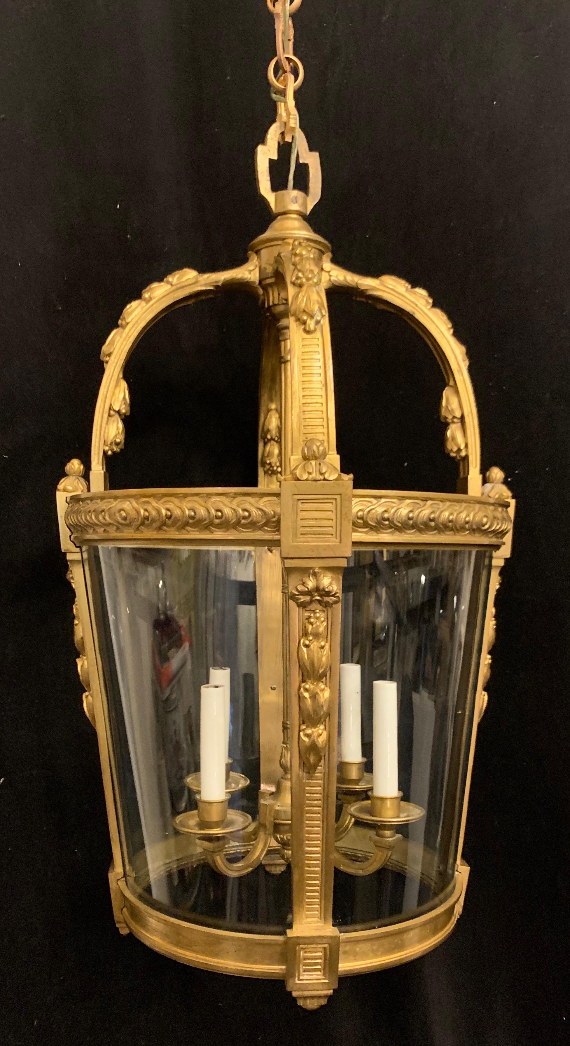 An outstanding French dore bronze filigree Louis XV style lantern chandelier with 4 candelabra lights on the interior. In the manner and quality of François Linke.