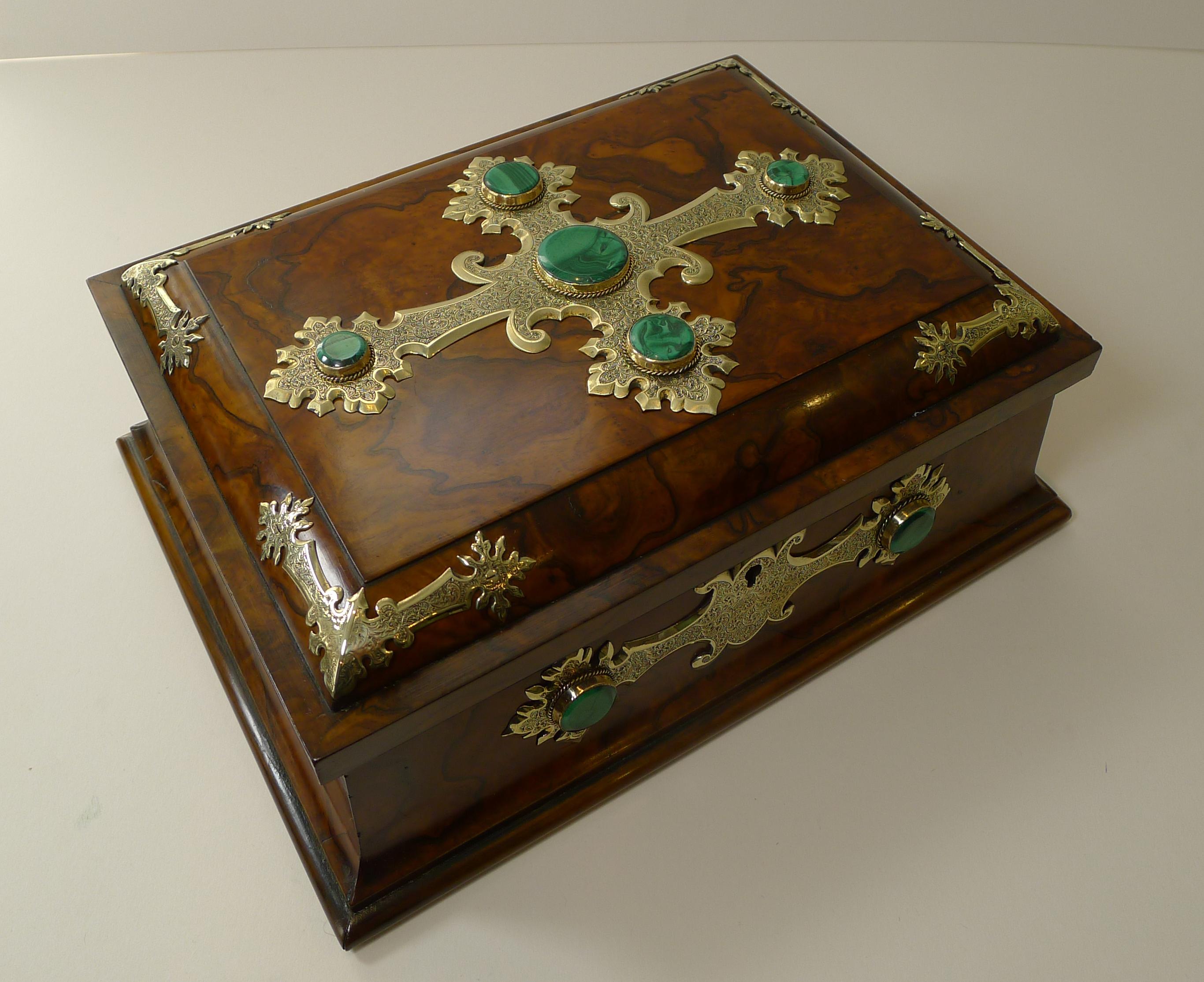 A stunning English Victorian Games / playing card box made from Burl Walnut mounted with impressive polished brass mounts beautifully detailed, and in turn, inset with polished green malachite stones.

The box comes with a working (replacement)