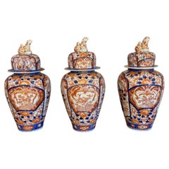Outstanding garniture of three antique Japanese imari vases and covers
