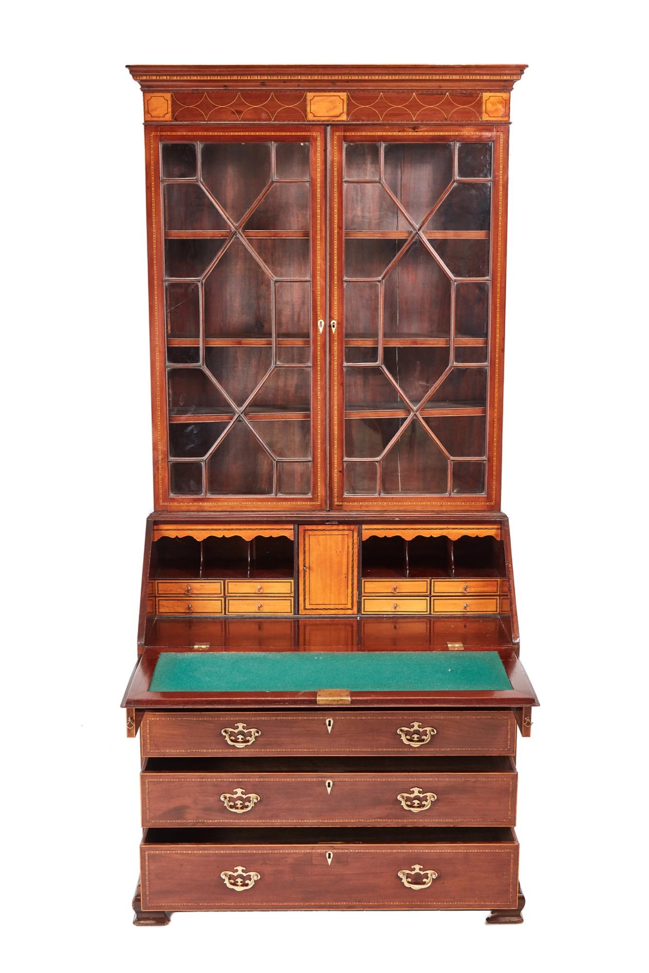Outstanding George III inlaid mahogany bureau bookcase, the upper section having a shaped mahogany cornice inlaid with satinwood, two astragal glazed doors enclosing three adjustable shelves, the bureau having a mahogany fall inlaid with satinwood,