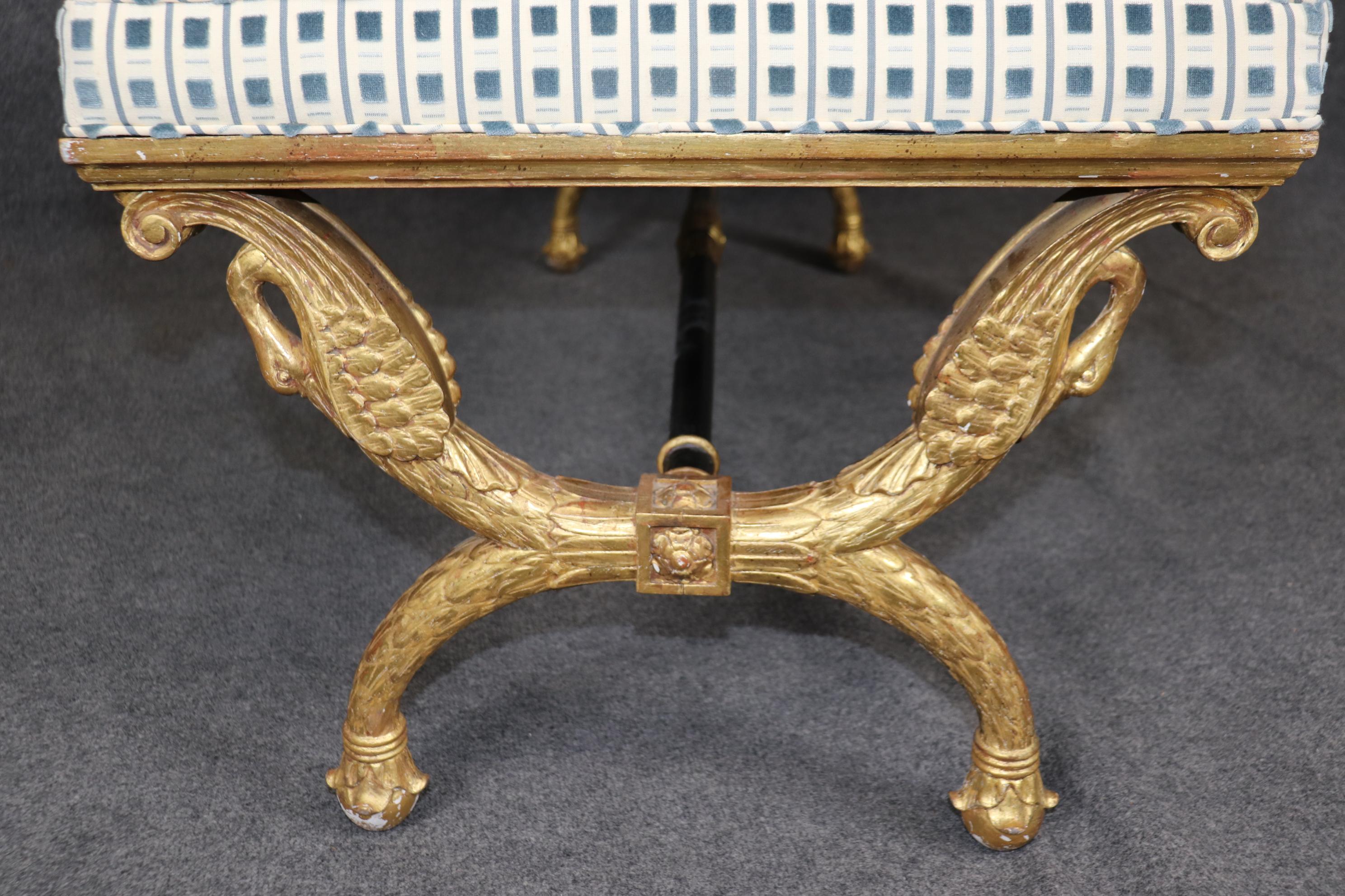 This is a stunning French-made giltwood bench with super carving and gorgeous vintage upholstery that really compliments the gilded frames. The carved swans are very naturalistically carved and absolutely stunning. The bench is absolutely unique and