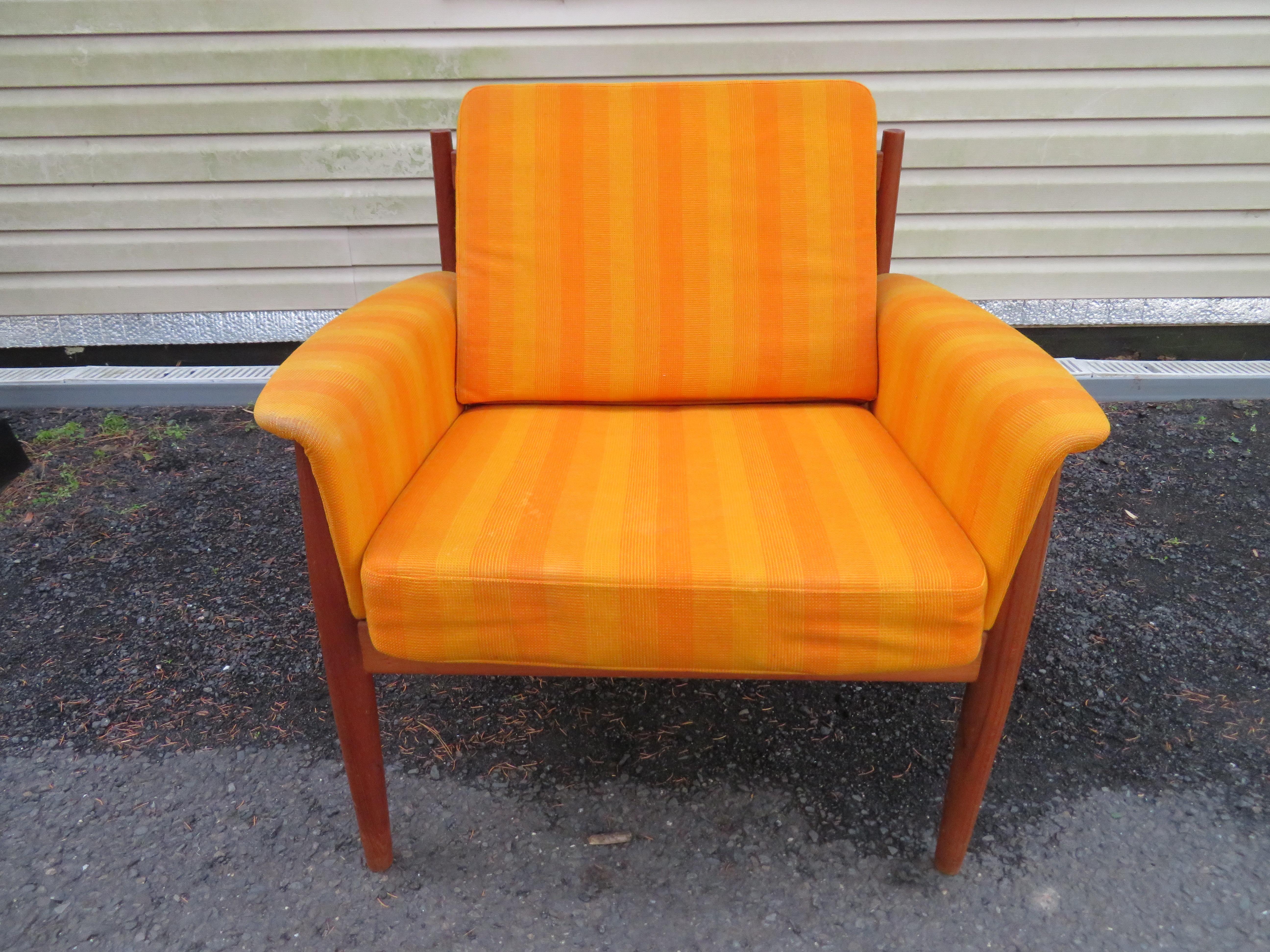 Outstanding Grete Jalk teak lounge chair. This chair retain its original orange striped woven fabric in nice vintage condition-some light spots-cleaning recommended. Very usable as is but would be spectacular in something fresh. The teak frame has a