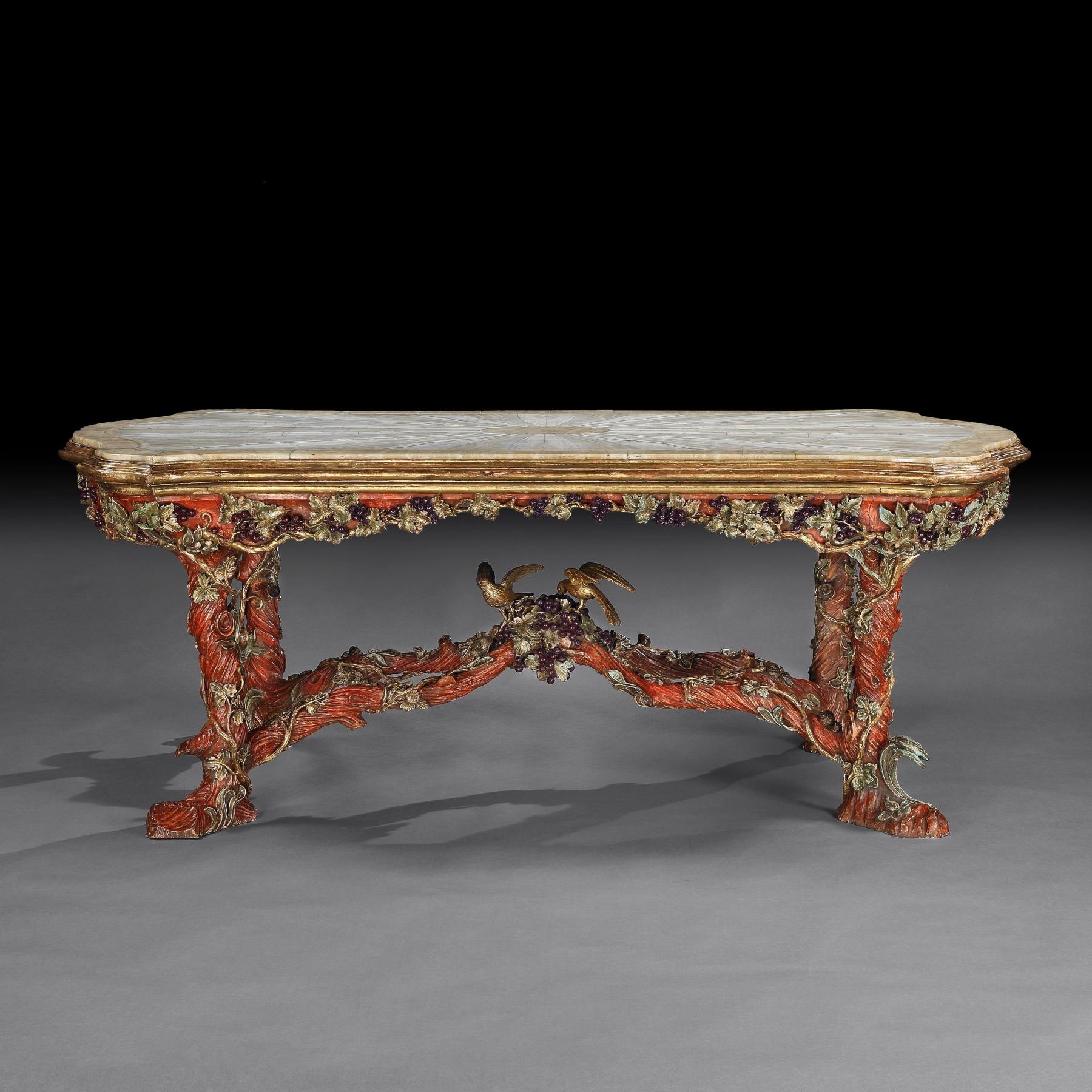 A one off masterpiece by Amulet Berton (1875 - 1967). Italian carved wood faux bois vine branch polychrome centre table parcel gilt with onyx top in the Venetian style.



Italy circa 1920-1930.



The elongated cartouche-shaped top inset