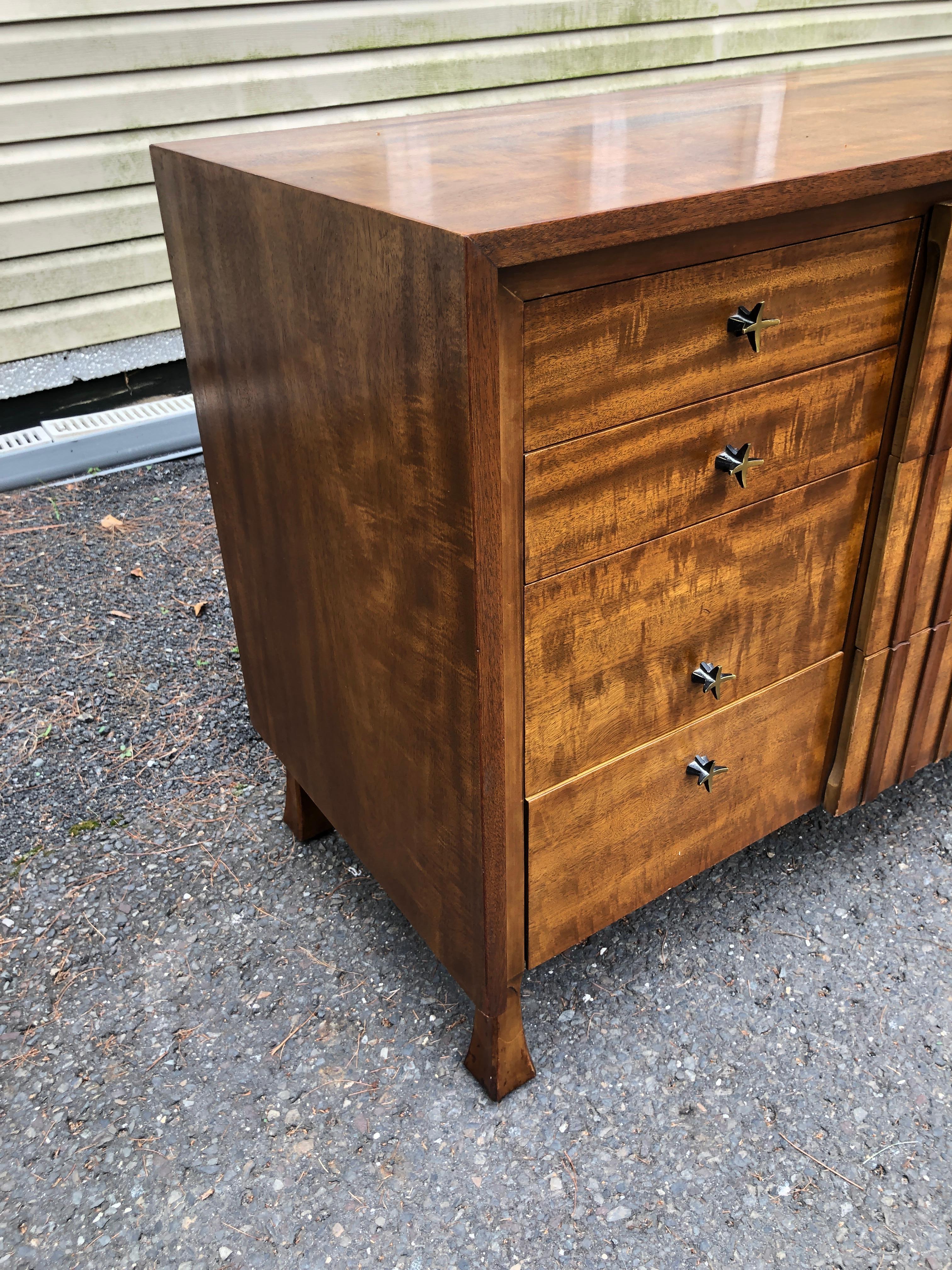 Outstanding John Widdicomb brutalist front walnut credenza.  We just love the spectacular star shaped pulls along with unusually shaped legs.  This special piece measures 31.5