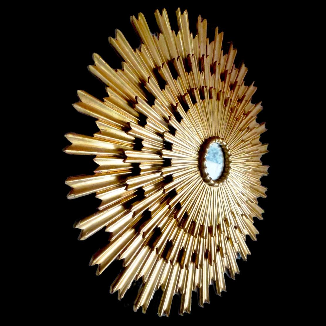 Huge beautiful three tiered sunburst mirror, with a round mirrored glass center in moulded frame.
Gold leaf polished on red bolus. 
Measures: Diameter 180cm 
 Timeless decoration for you interior.



