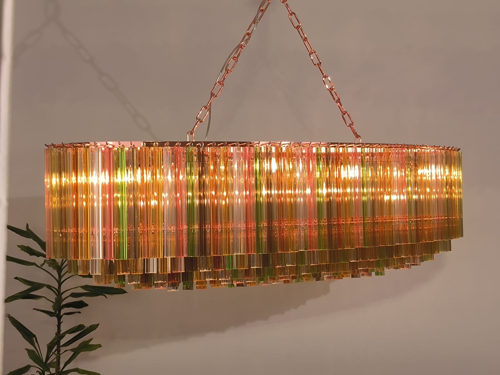 Outstanding Murano chandelier made by Murano crystal multicolored triedi prism on six levels with copper color metal frame.
The glasses are amber, transparent, , smoky, amber, gold,  pink , clear  and green , creating a fabulous light effect.
 We