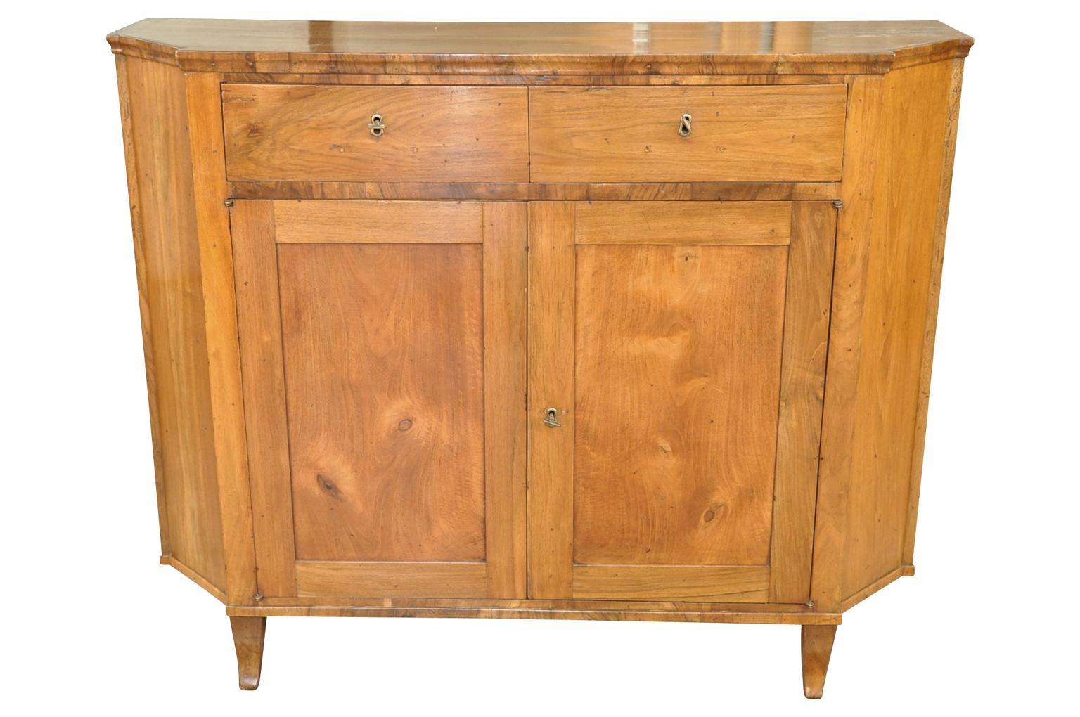 An outstanding and spectacular later 18th-early 19th century Venetian credenza. Wonderfully constructed from stunning walnut with very clean and elegant lines, canted sides, two drawers with interior shelf. Very rich and luminous patina.