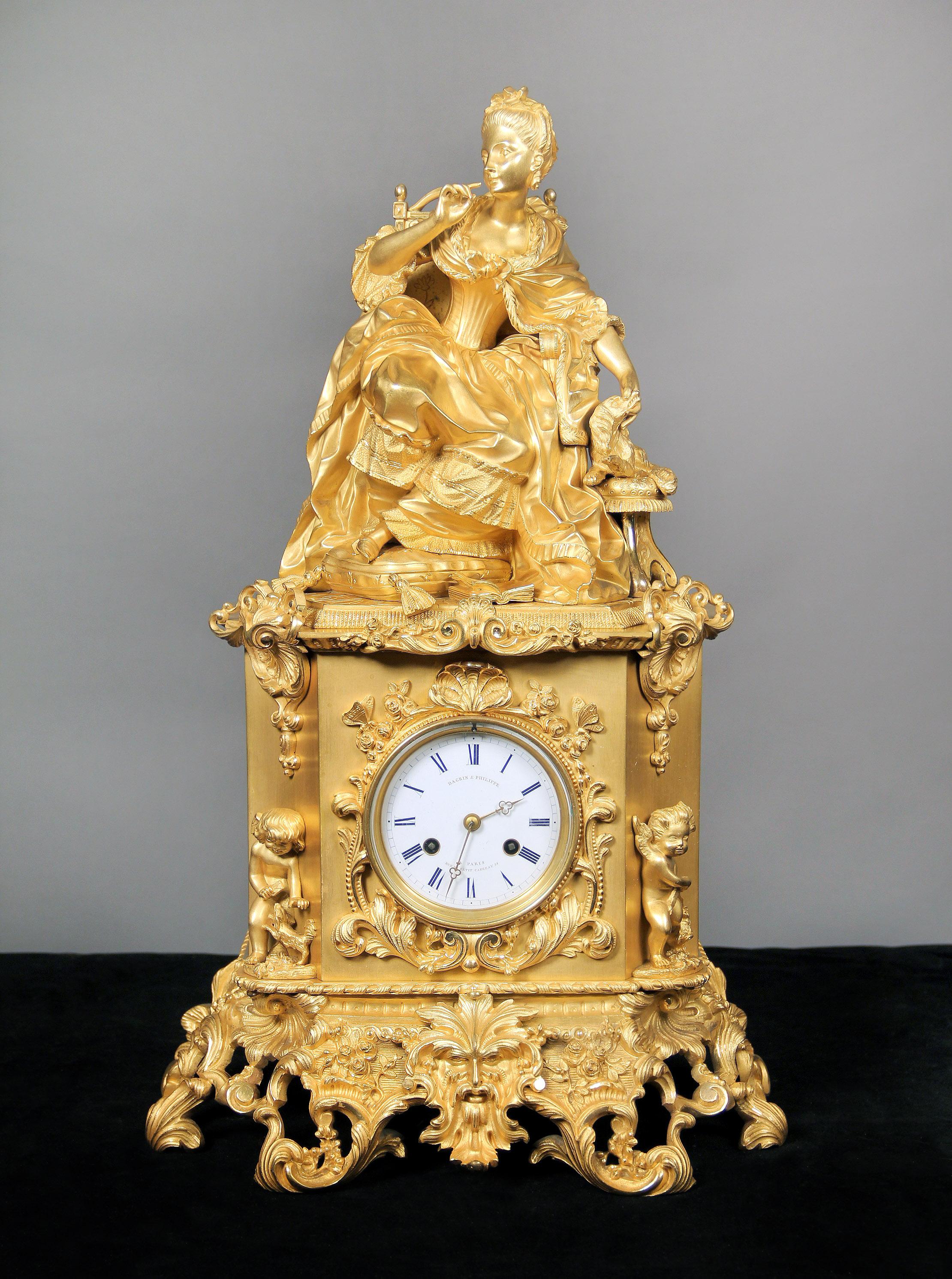 An outstanding late 19th century gilt bronze mantel (fireplace) clock by Dagrin and Philippe

By Dagrin and Philippe

A large gilt bronze, beautifully dressed sculpture of Marie Antoinette sitting with her dog on top of an intricately designed clock
