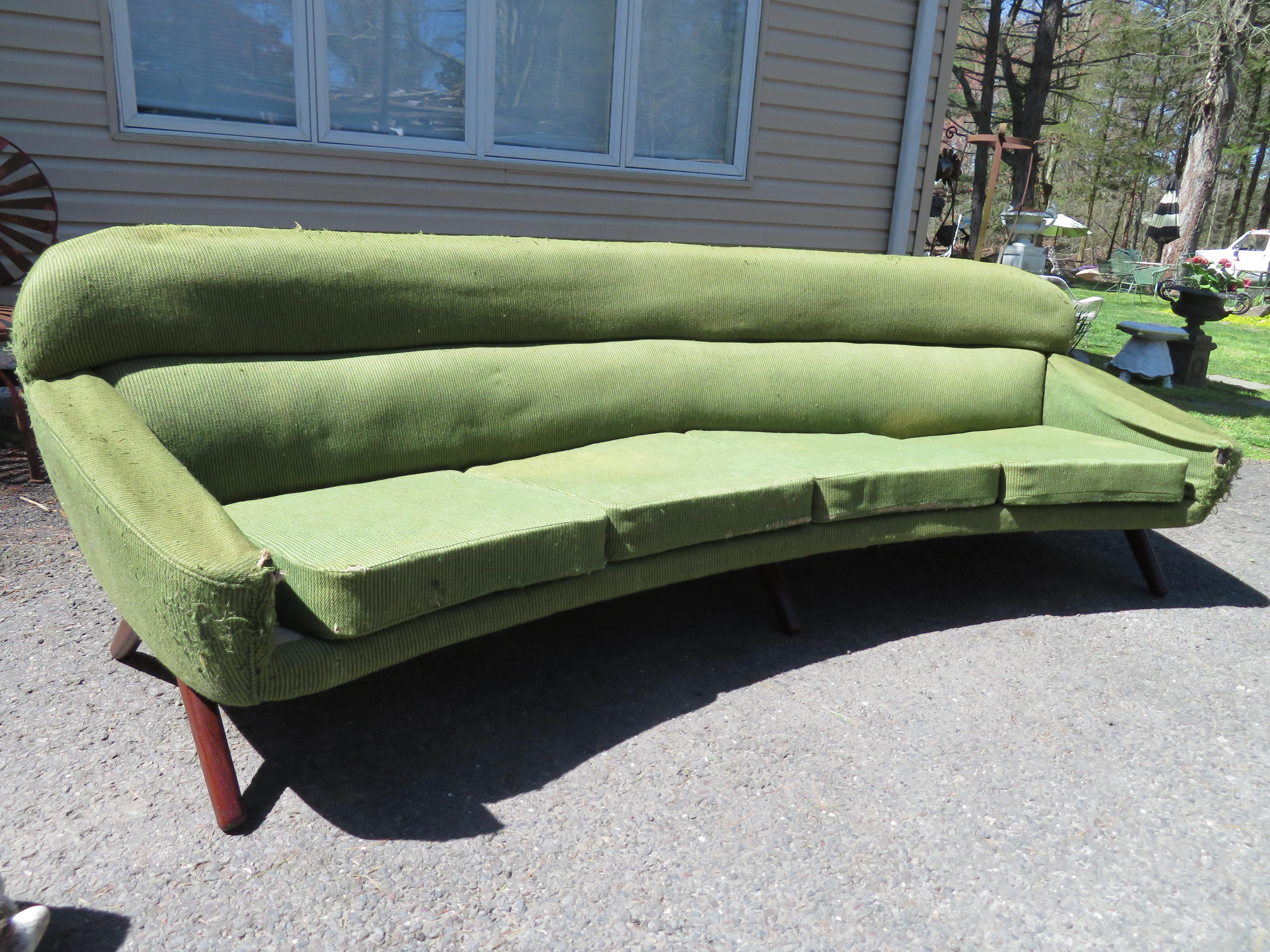 Stylish and rare Danish Modern Leif Hansen style curved sofa with amazing walnut legs. This sofa will need to be reupholstered but the bones are fabulous! It measures 29