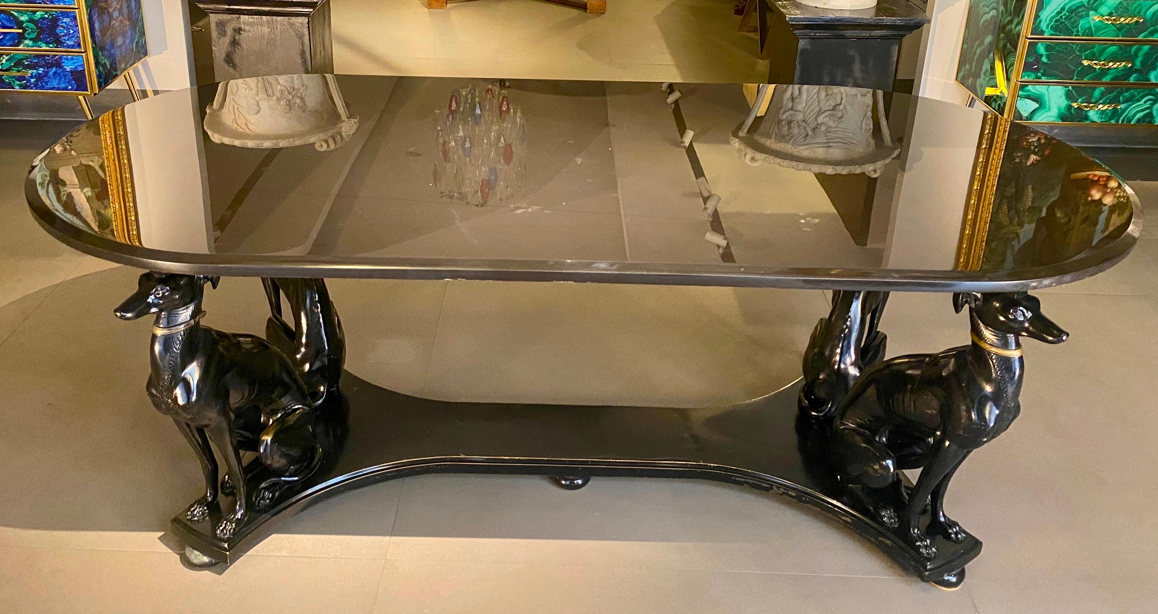 Exceptional Mid -Century black patinated bronze dining or center table supported by four elegant grayhound dog sculptures .
 Precious  Belgian black marble top.
 Masterpiece of Italian Mid-Century craftsmanship . Very good original condition . 
 
 