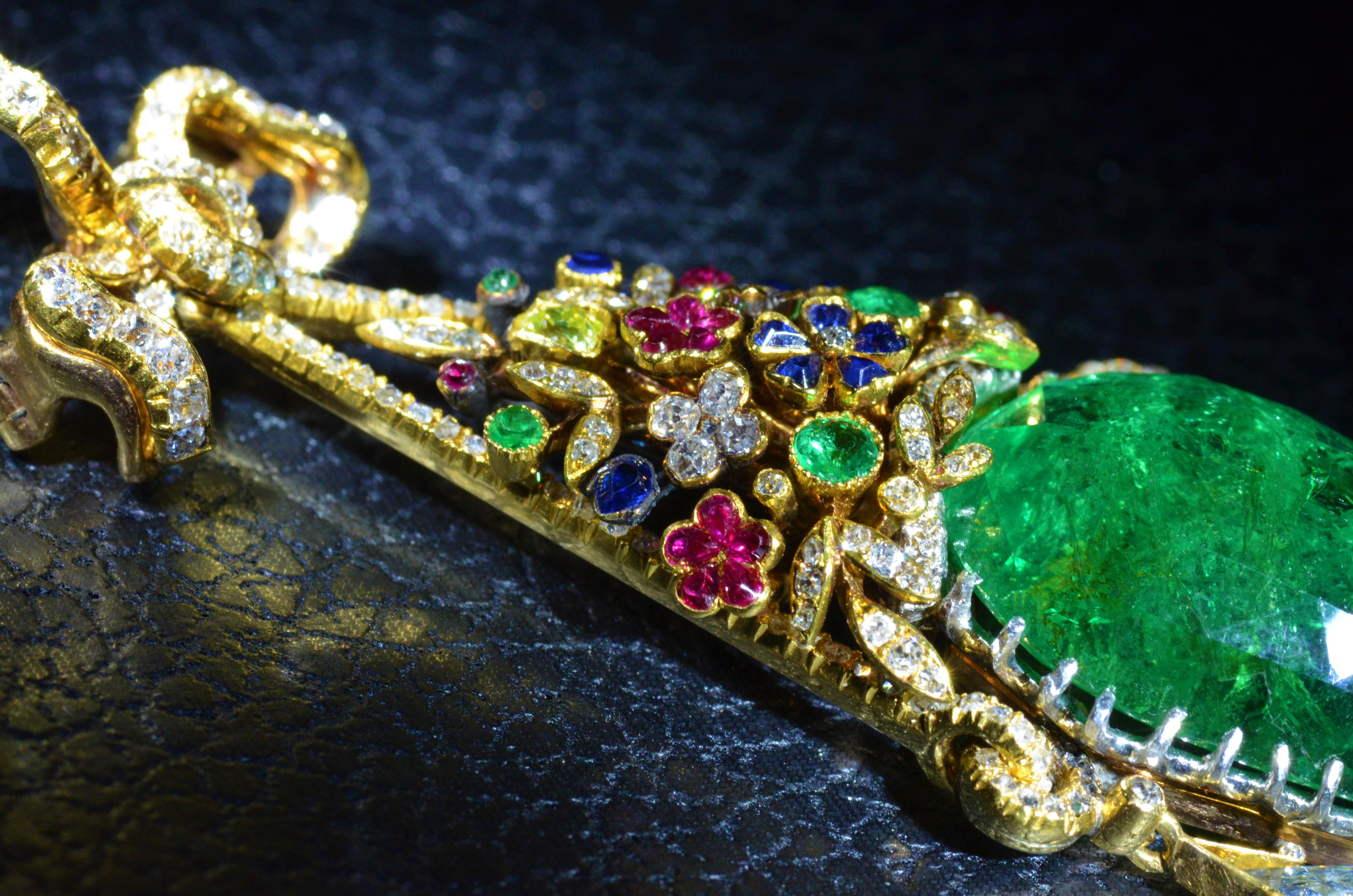 Outstanding Multi-Gem Pendant Brooch by Frederic Boucheron featuring an old mine cut and rose-cut diamond ribbon-bow, suspending a floral bouquet of variously-cut sapphires, rubies, emeralds and an old-cut yellow diamond.  Below an important pear