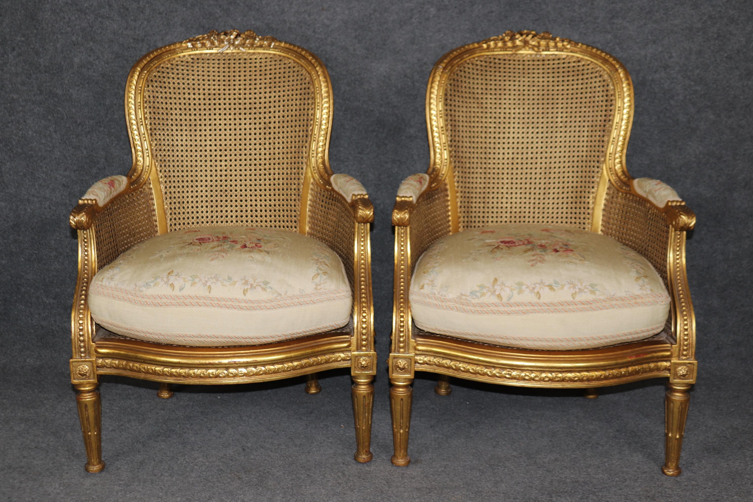 This is a fantastic set of absolutely luminous gold leaf caned and Aubusson upholstered bergère chairs. The chairs are in very good condition for their age and have minor signs of age and use such as minor stains or issues with upholstery and no