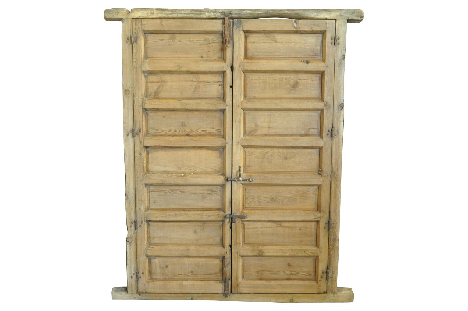 An outstanding pair of 17th century doors in their surround from the Catalan region of Spain. Handsomely constructed from Meleze wood. Beautiful to build into any interior or exterior door way - or used as a headboard for a bed.