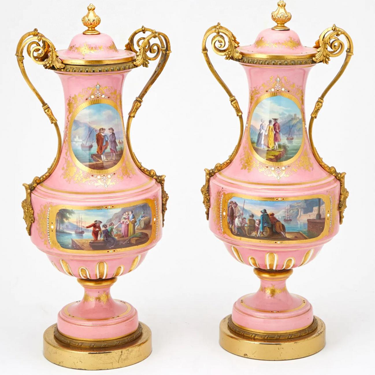 Outstanding Pair of Gilt-Bronze Mounted Jeweled Porcelain Mascron Handled Vases with Covers 

In the Sèvres style, each vase is decorated with unique hand painted scenes of bucolic seascapes and figures in a port town, encircled by fine golden