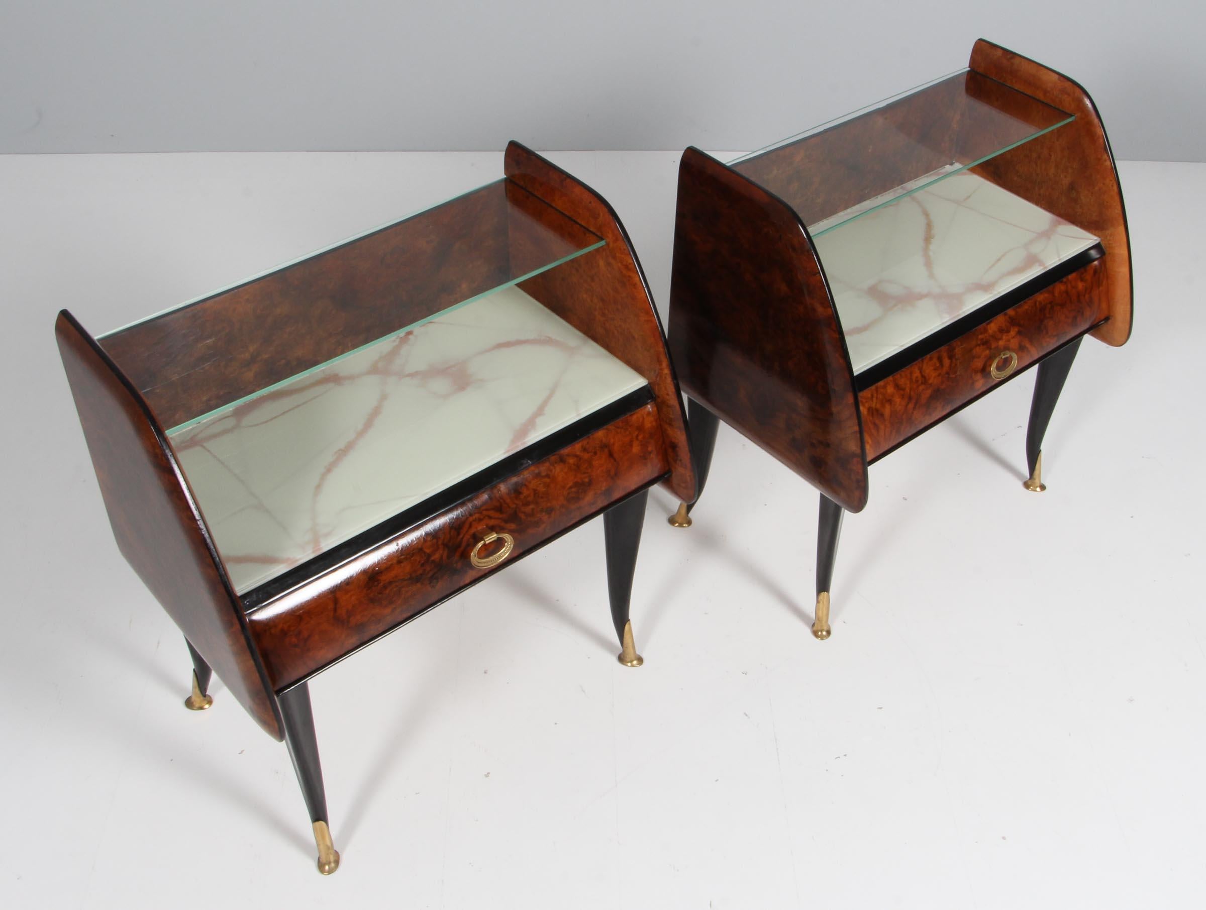 Art Deco Italian night stands with glass tops and brass details.

Made of veenered root tree.

Probably made in the 1960s.