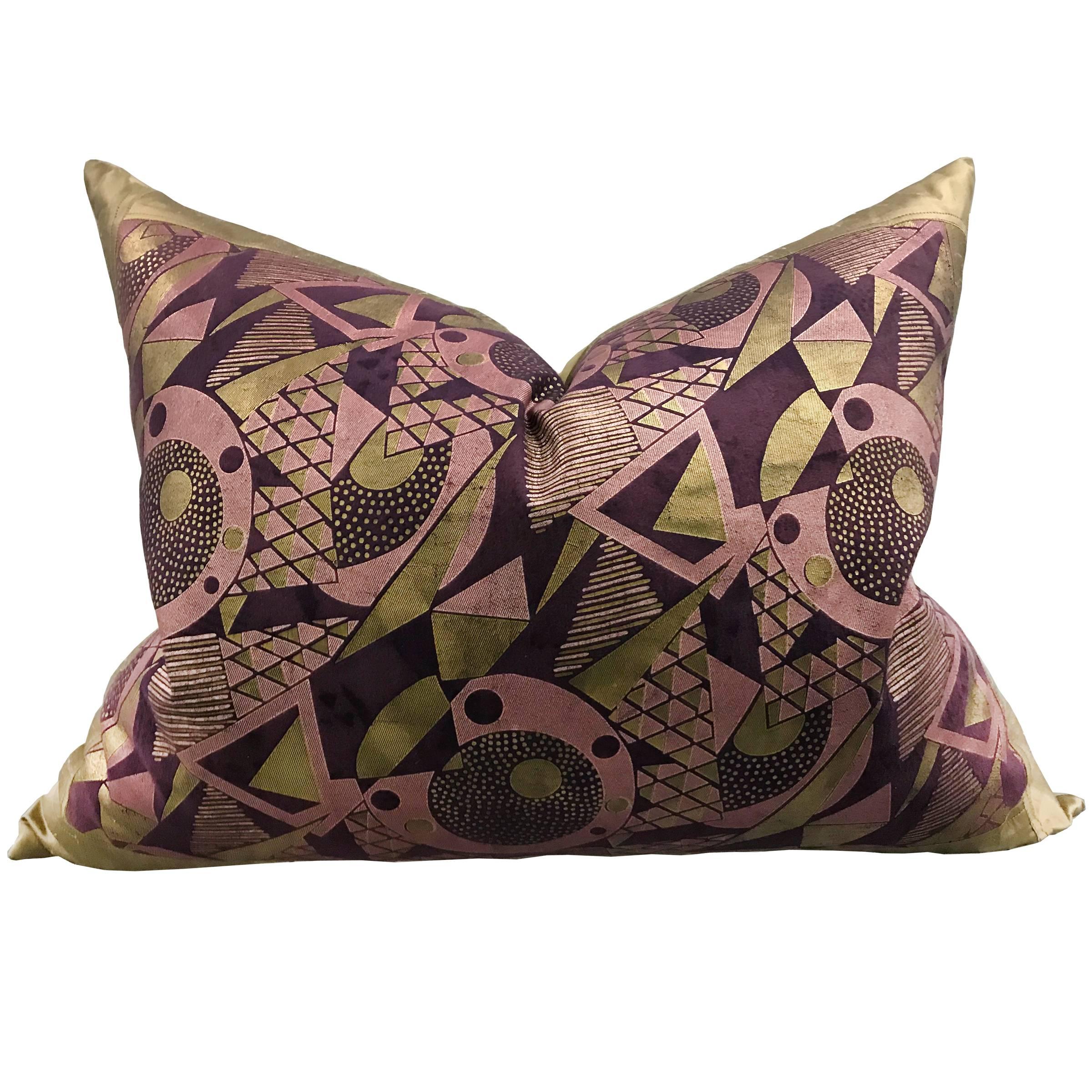 An outstanding pair of pillows constructed from early 20th century Japanese Art Deco velvet panels with a classic geometric patterns silk screened with gold and pink ink. Backed in gold silk, and filled with down.