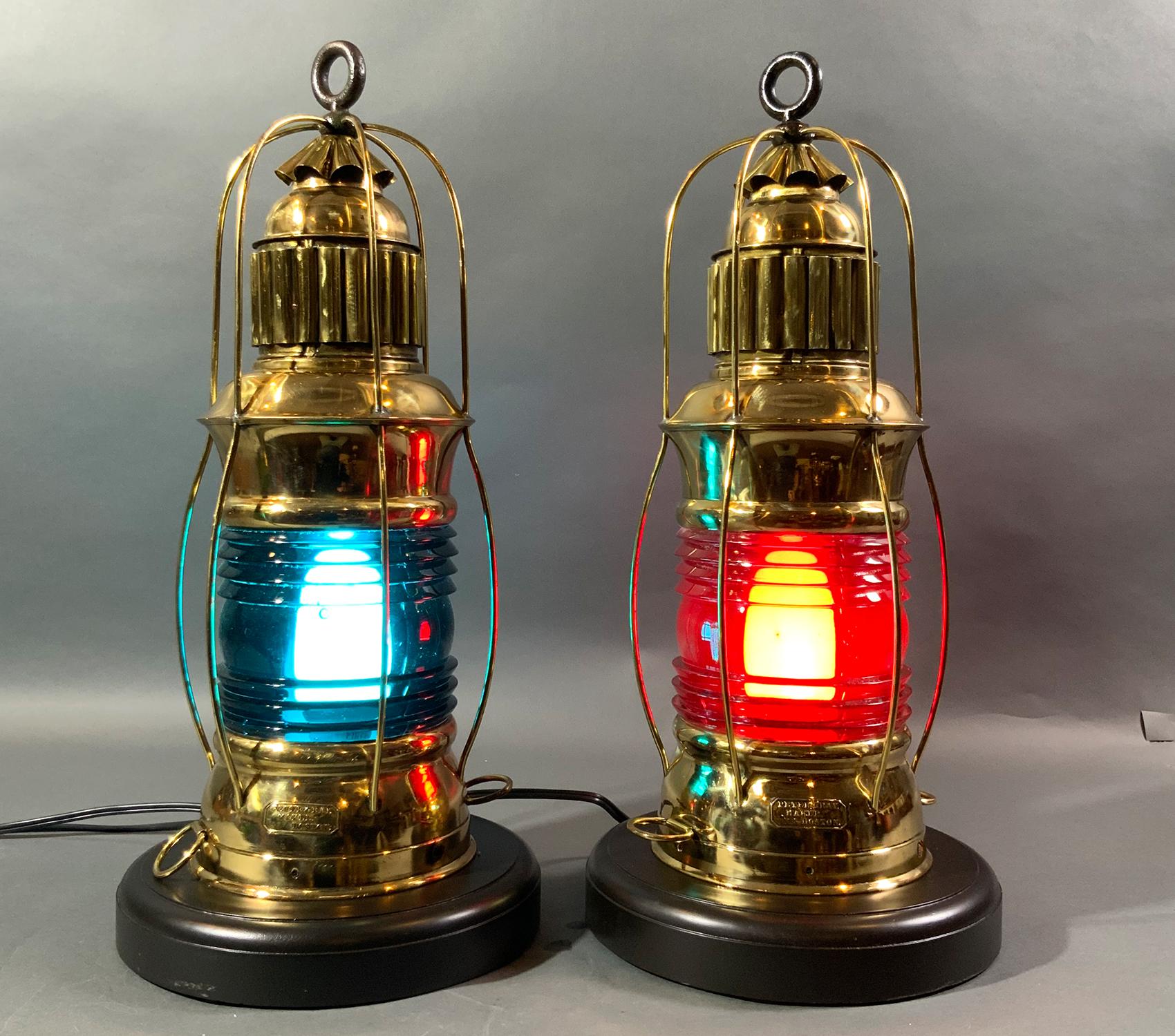 Very fine and rare pair of polished and lacquered ships lanterns with makers badges from Peter Gray of Boston. This is a great pair with rich red and blue Fresnel glass lenses set into brass cases with protective bars, vented tops and hoisting