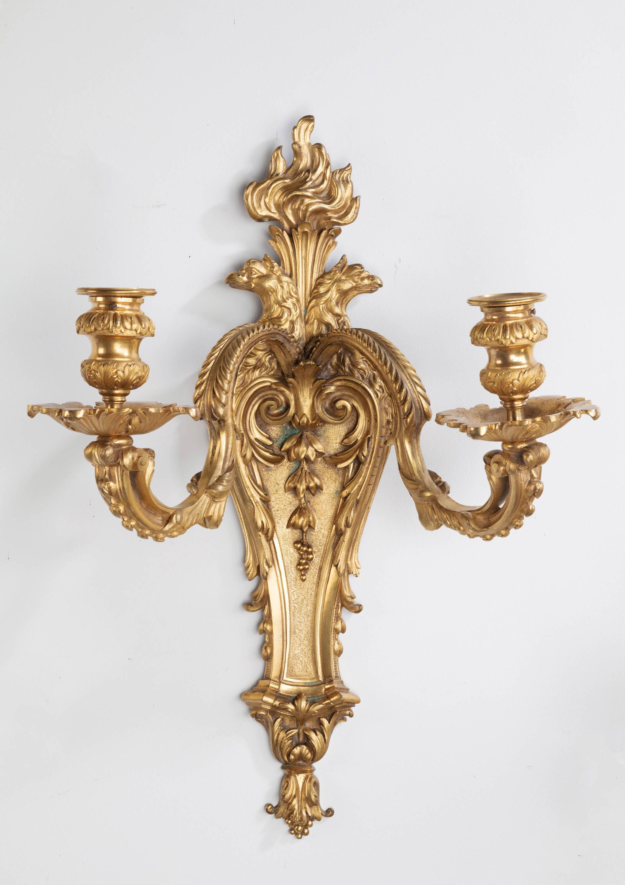 A quite outstanding pair ormolu two-arm wall lights in the baroque manner. The waisted central wall piece and fronds draped in foliage. Two finally carved upper arms. The whole of quite exceptional quality.