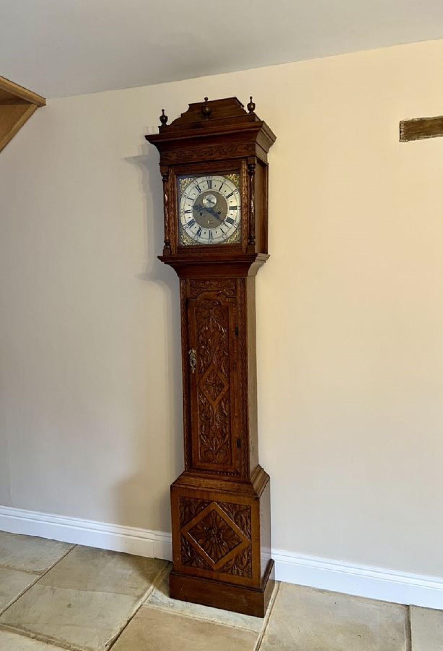 Outstanding quality 18th century carved oak long case clock by Smith Macclesfield, having an outstanding quality carved oak case with three finials to the top of the case, a brass face with a silvered dial and the original hands, signature signed,
