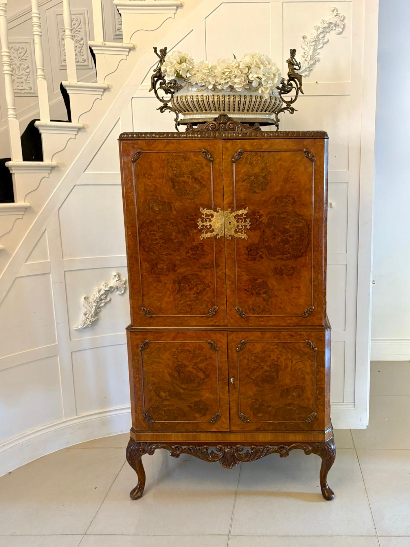 Meuble à cocktail en ronce de noyer d'une qualité exceptionnelle. La partie supérieure présente un plateau poli et un fronton en noyer sculpté au-dessus d'une paire de portes en ronce de noyer de qualité, avec une ravissante plaque de serrure en