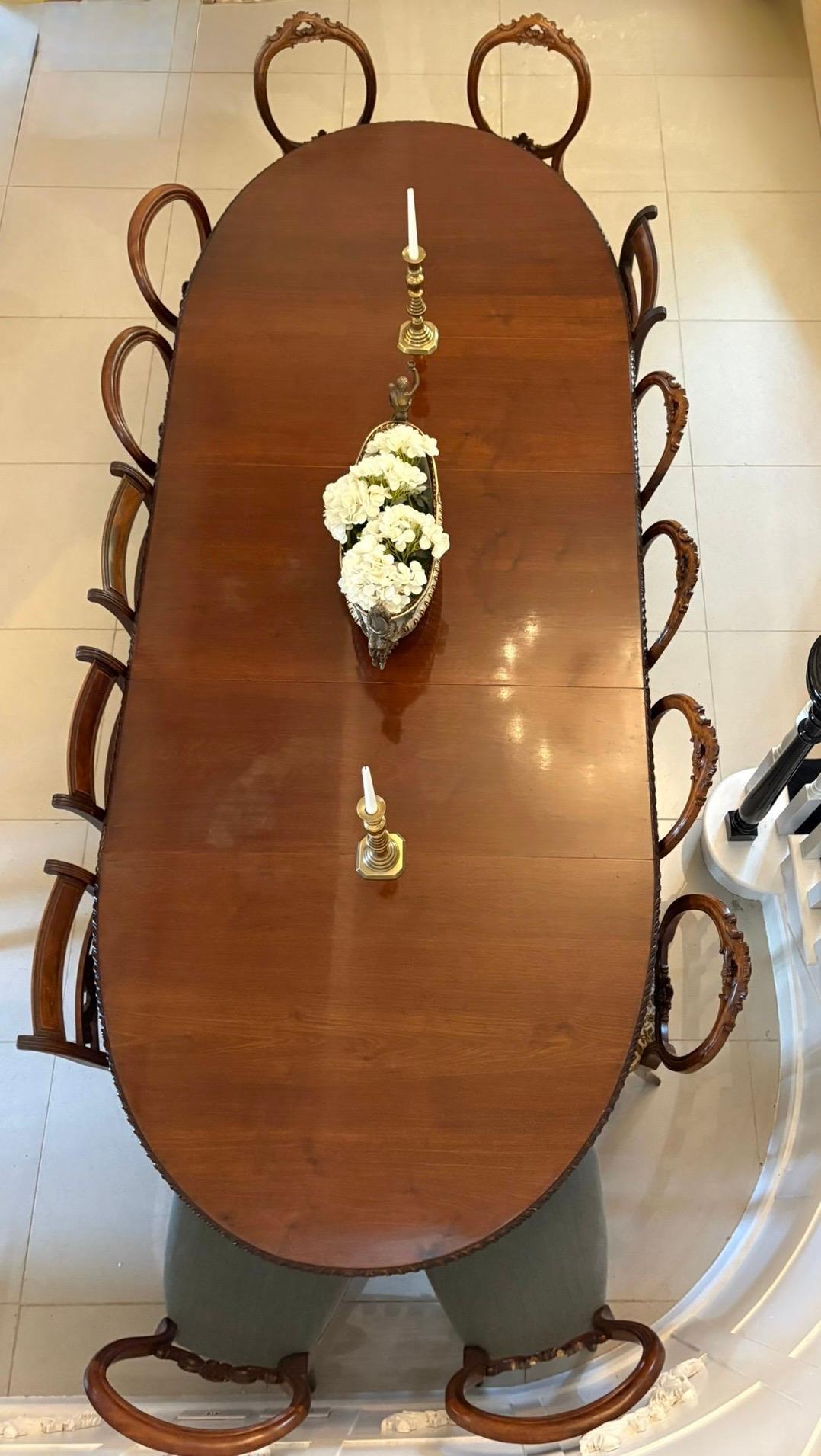 Outstanding quality antique Victorian carved mahogany 14 seater extending dining table having a large oval quality mahogany top with a carved edge and 3 original extra leaves, mahogany frieze, original wind out extending mechanism standing on 4