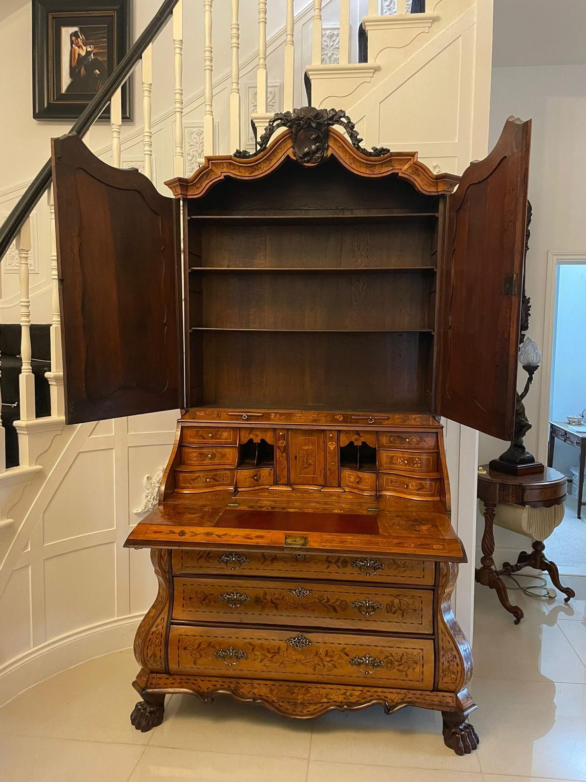 Outstanding quality 18th century antique Dutch marquetry inlaid burr walnut bureau bookcase having an outstanding quality Dutch marquetry inlaid burr walnut bureau bookcase with a beautiful carved shaped cornice above a pair of marquetry inlaid