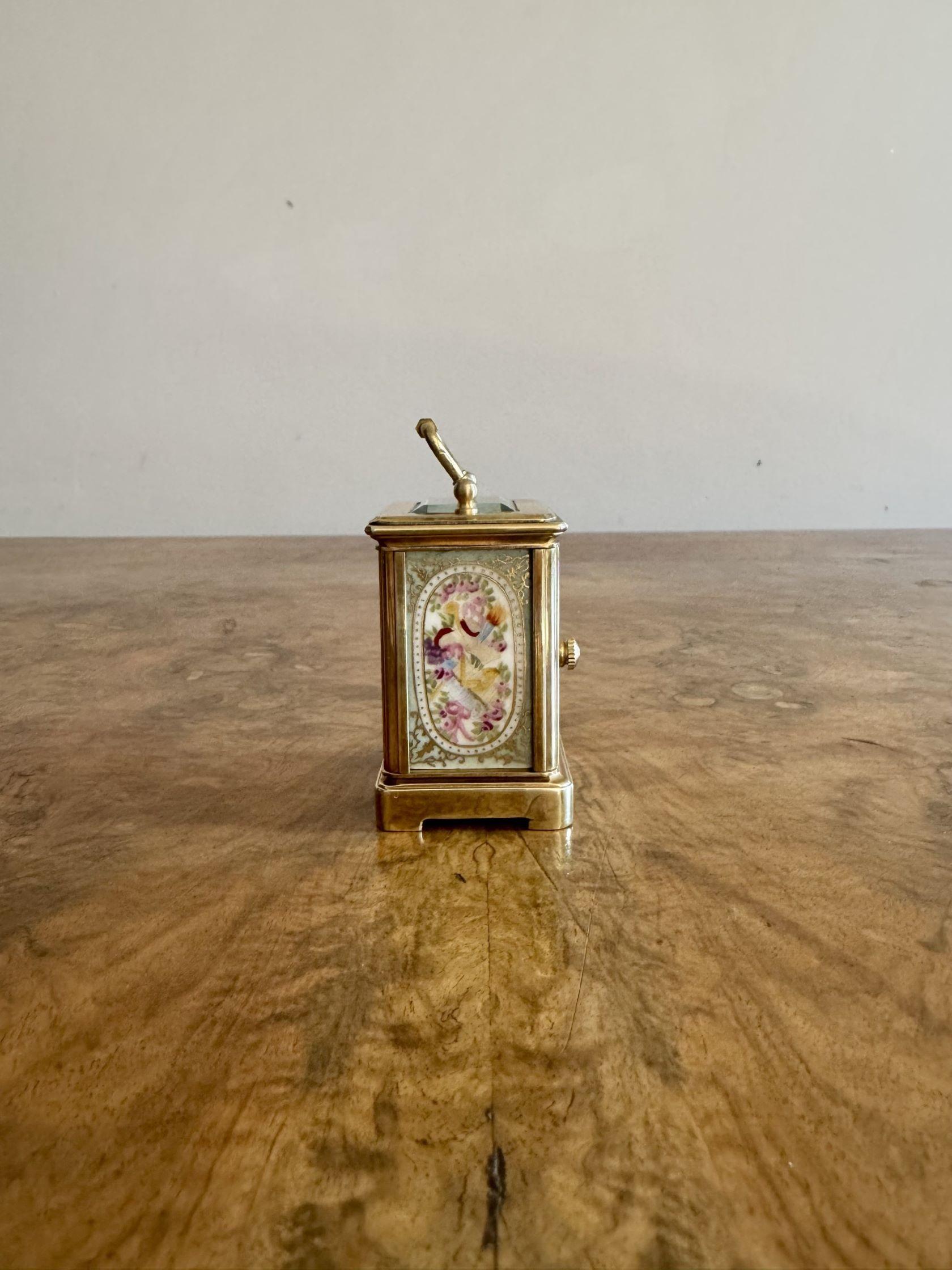Outstanding quality antique Edwardian miniature carriage clock having a quality brass case with beautiful hand painted porcelain panels decorated with flowers and instruments in green, pink, blue and yellow colours surrounded by gold scrolls, having