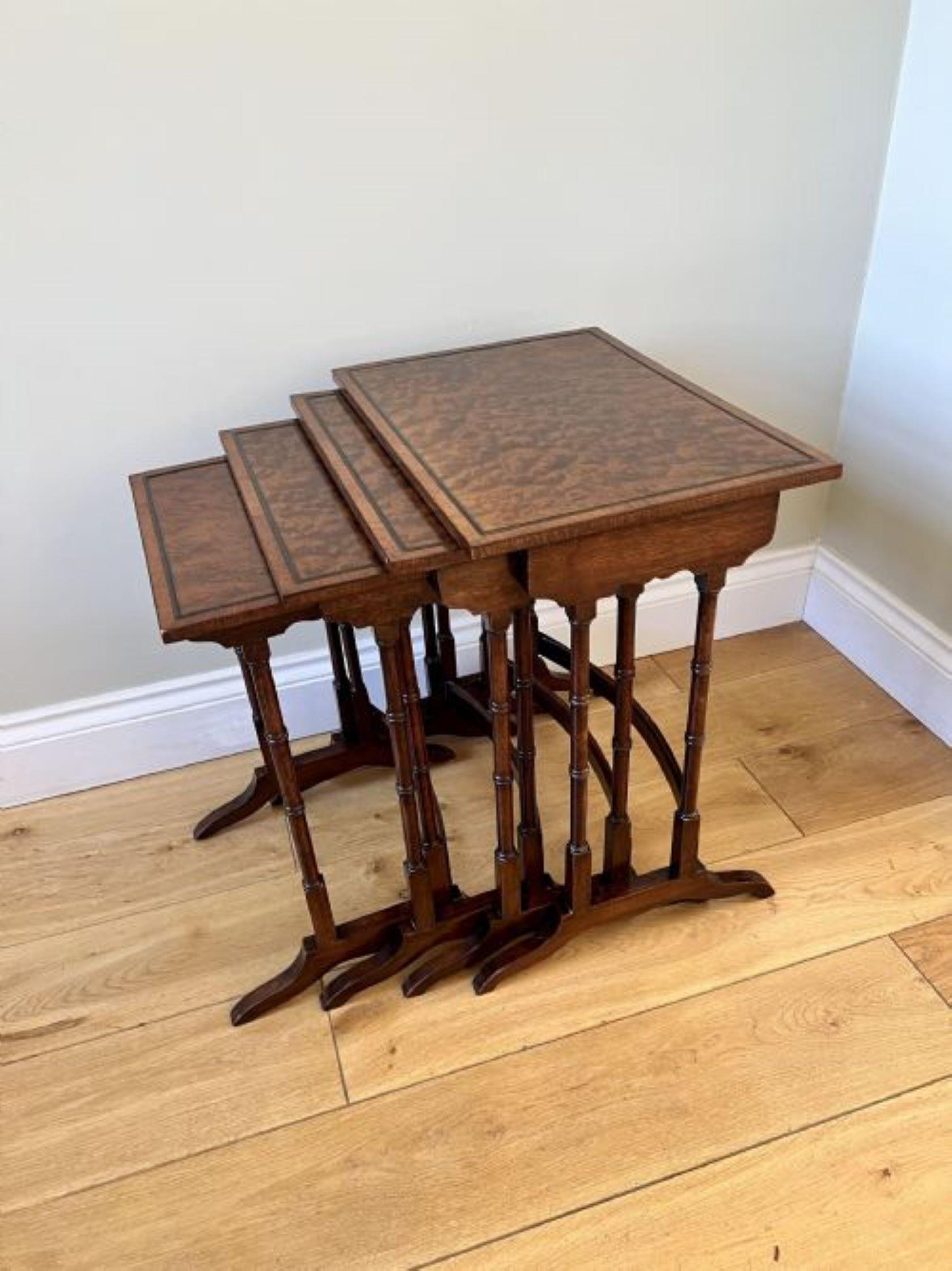 Outstanding quality antique Edwardian nest of four burr walnut tables, having outstanding quality burr walnut tops with a moulded edge, supported on elegant turned columns standing on shaped feet united by a shaped stretcher.