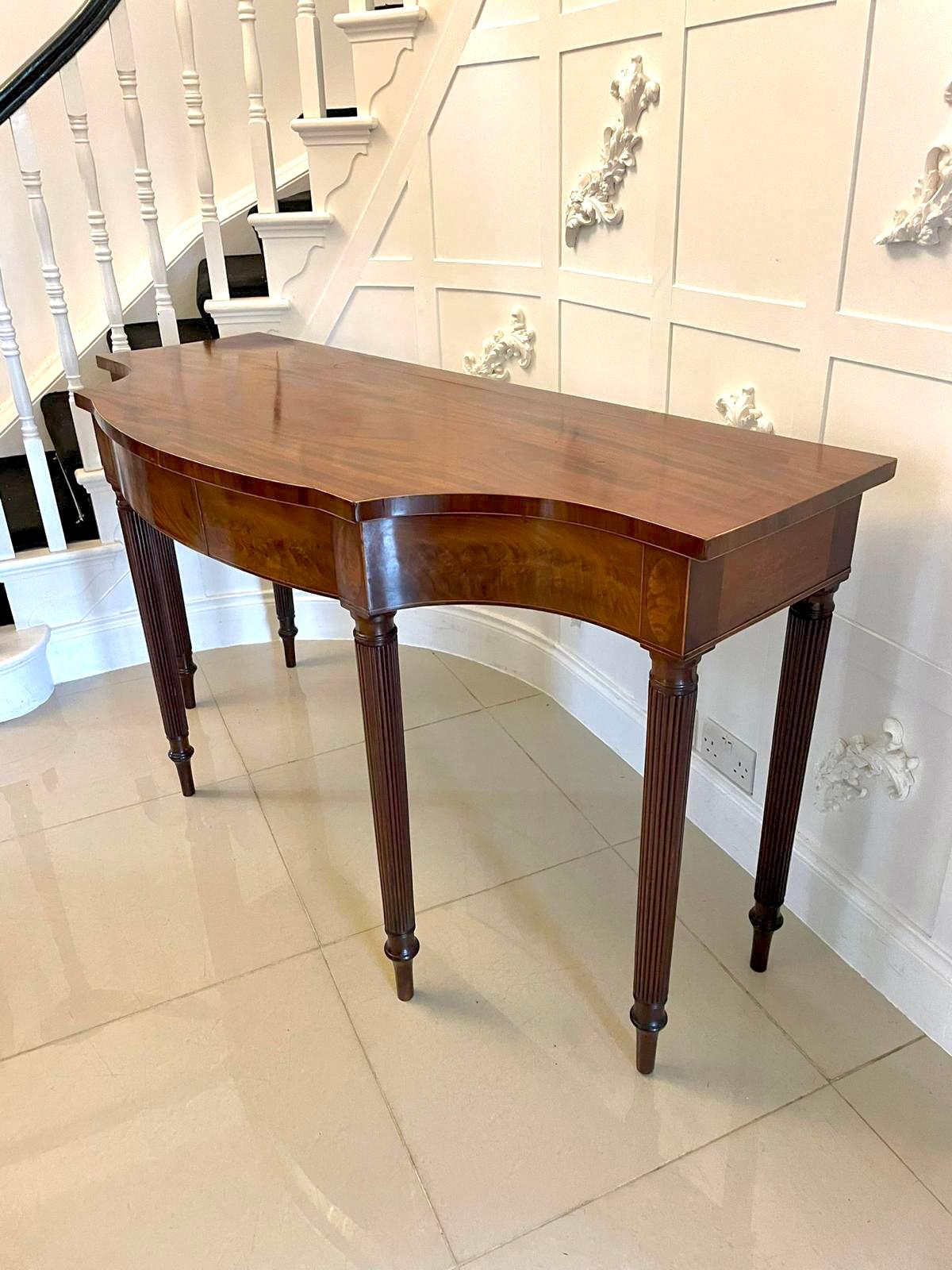 Outstanding quality antique George III figured mahogany serpentine shaped serving/console table having an outstanding quality figured mahogany serpentine shaped top with satinwood inlay stringing to the edge above a figured mahogany serpentine shape