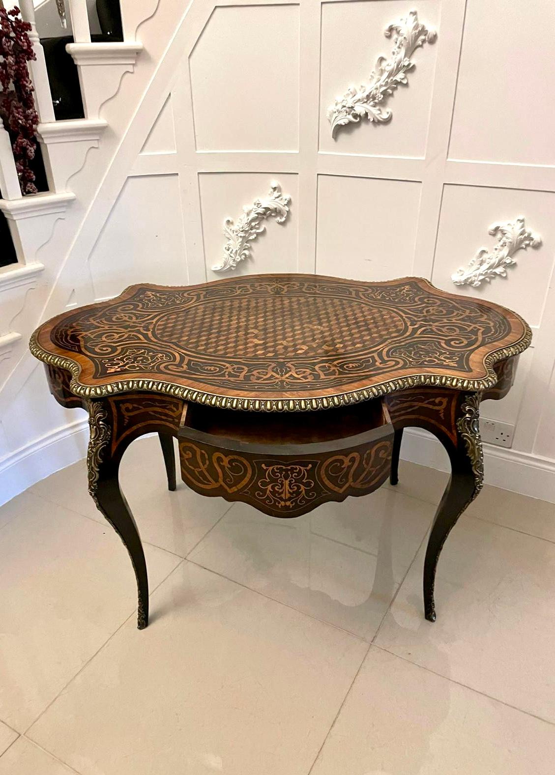 
Outstanding quality antique Victorian French freestanding marquetry and parquetry centre table 
having a magnificent quality serpentine shaped marquetry and parquetry inlaid top with an ornate ormolu edge, inlaid marquetry serpentine shaped