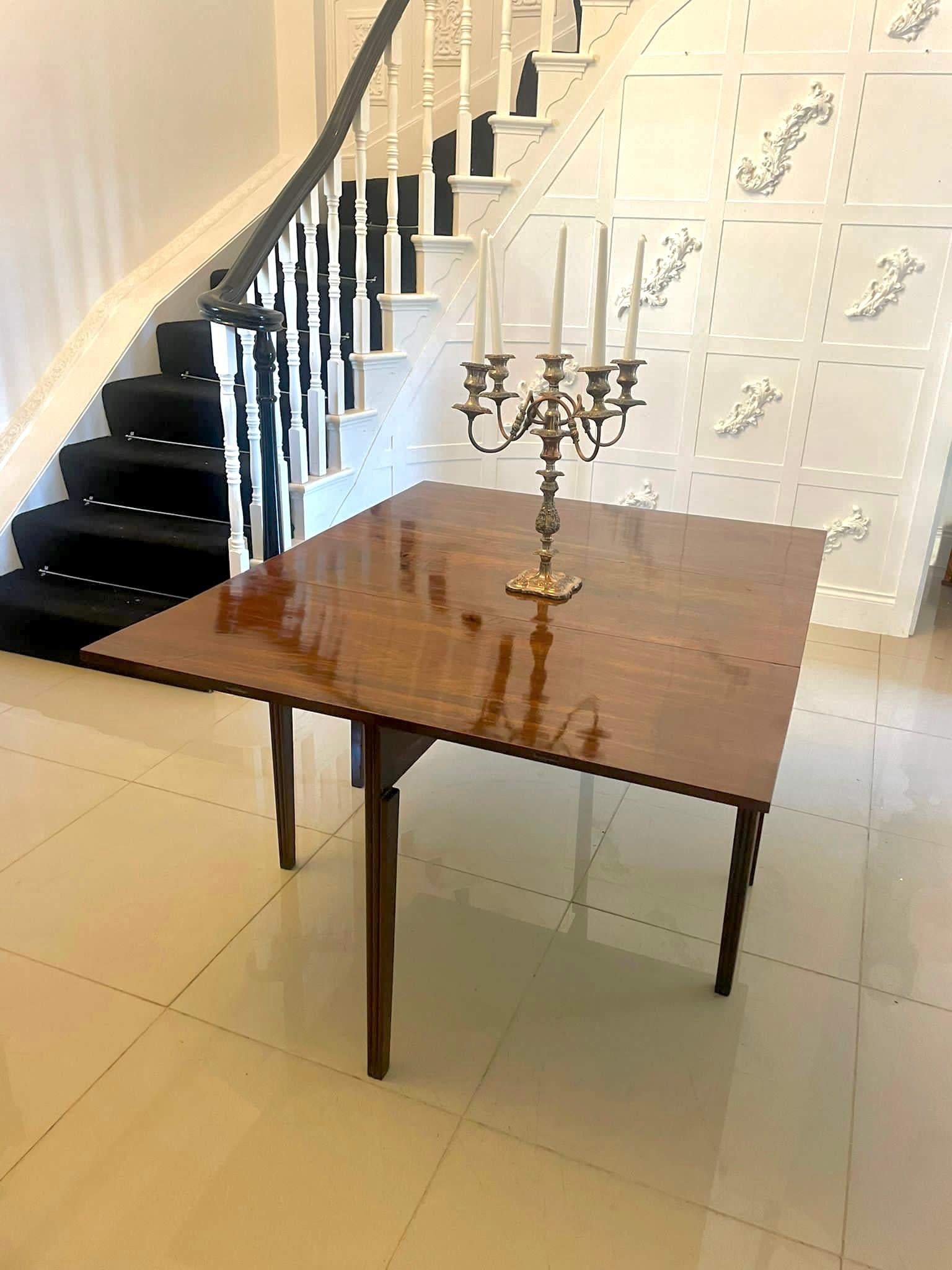 Outstanding quality antique George III figured mahogany metamorphic dining table having an outstanding quality figured mahogany top with D shaped ends and a drop leaf table to the centre standing on elegant square tapering reeded legs. This table