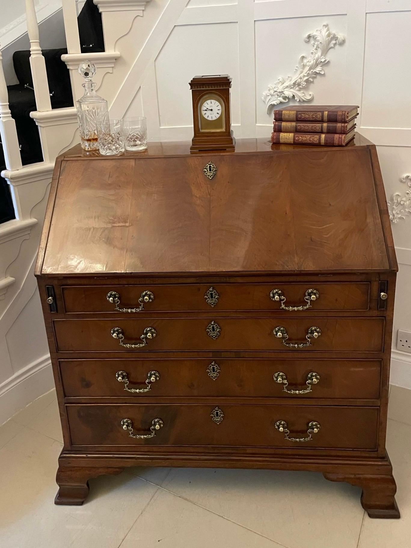Outstanding quality antique George III mahogany bureau having a figured mahogany fall with a moulded edge opening to reveal a fitted interior consisting of drawers and pigeon holes above four long drawers with oak lining, cockbeeded edges and