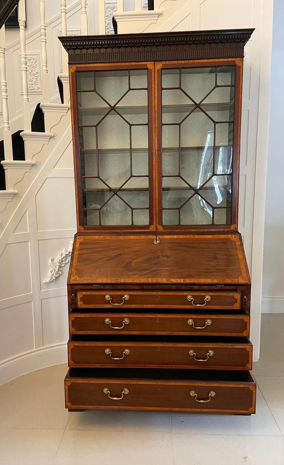 Outstanding quality antique George III mahogany inlaid bureau bookcase having an outstanding quality carved cornice above a pair of mahogany inlaid satinwood astral glazed doors opening to reveal three adjustable shelves above a fantastic bureau