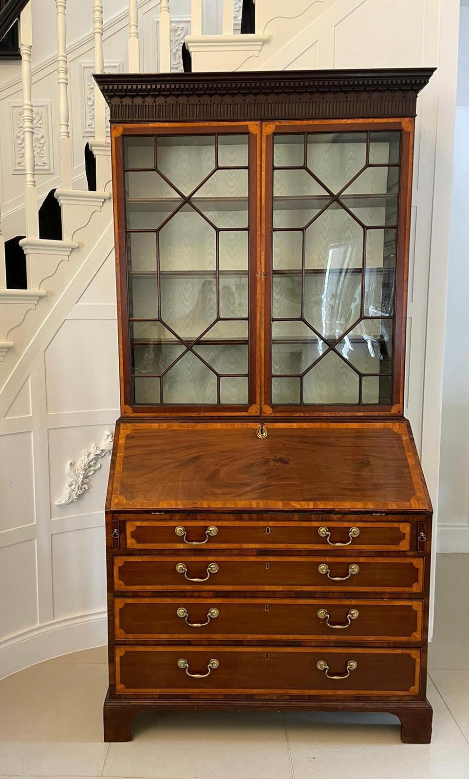 Outstanding quality antique George III mahogany inlaid bureau bookcase having an outstanding quality carved cornice above a pair of mahogany inlaid satinwood astral glazed doors opening to reveal three adjustable shelves above a fantastic bureau