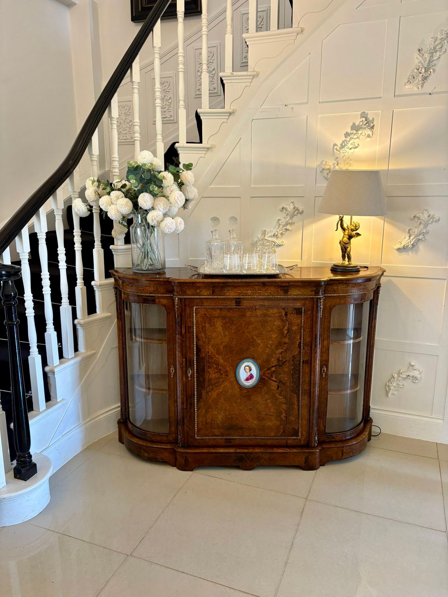 Outstanding quality antique Victorian inlaid burr walnut porcelain mounted credenza having a burr walnut shaped top with a moulded edge above an inlaid burr walnut shaped frieze above a single inlaid burr walnut door with a hand painted oval