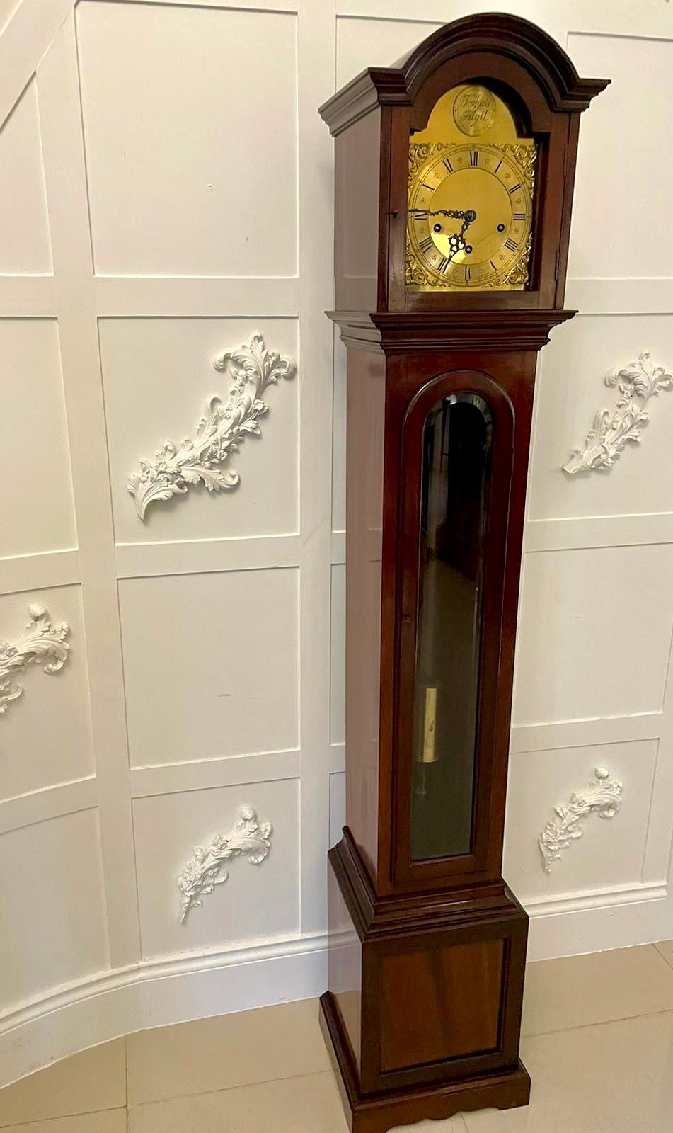 Outstanding quality antique mahogany 8 day chiming grandmother clock having an outstanding quality mahogany case with a long bevelled edge glass door, brass arched dial with original hands, 8 day movement chiming every 15 minutes and striking on the