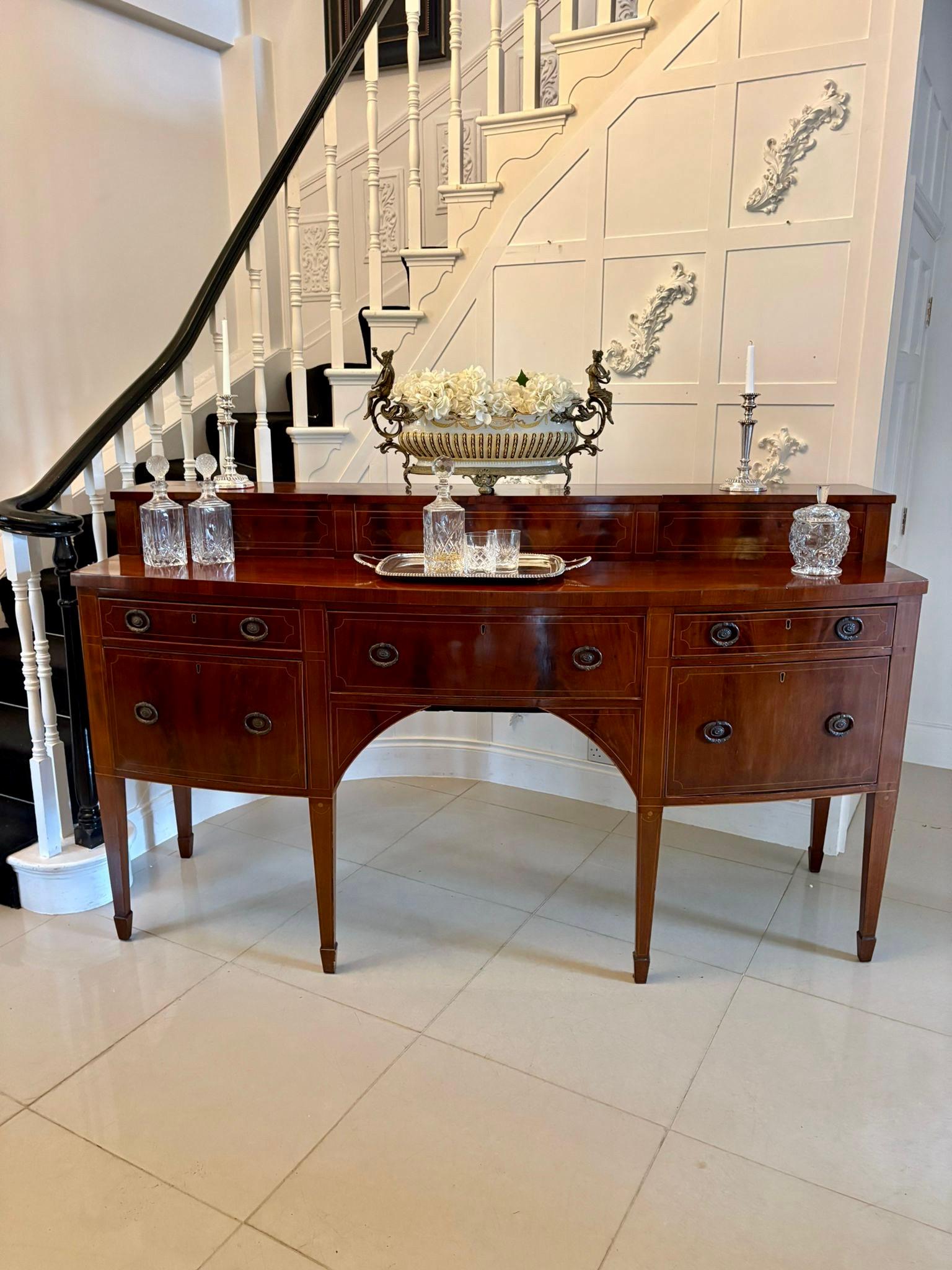Outstanding quality large antique George III mahogany and boxwood strung bow fronted sideboard having a magnificent quality mahogany inlaid raised superstructure with two sliding doors opening to reveal storage compartments above a figured mahogany