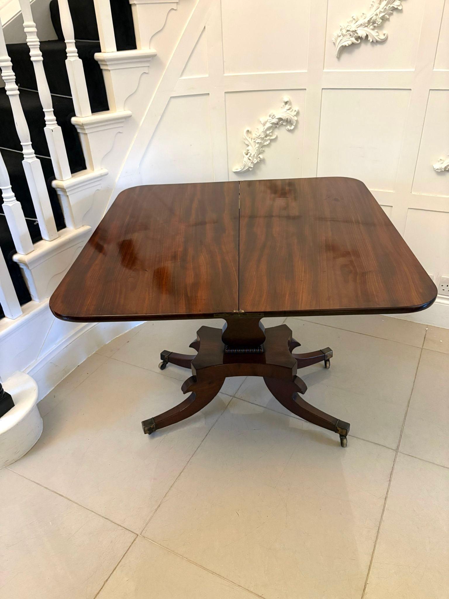 Outstanding quality antique Regency figured mahogany tea/console table having a marvellous quality figured mahogany swizzle top opening to reveal a polished interior, mahogany brass inlaid frieze supported by a shaped pedestal column with a beaded