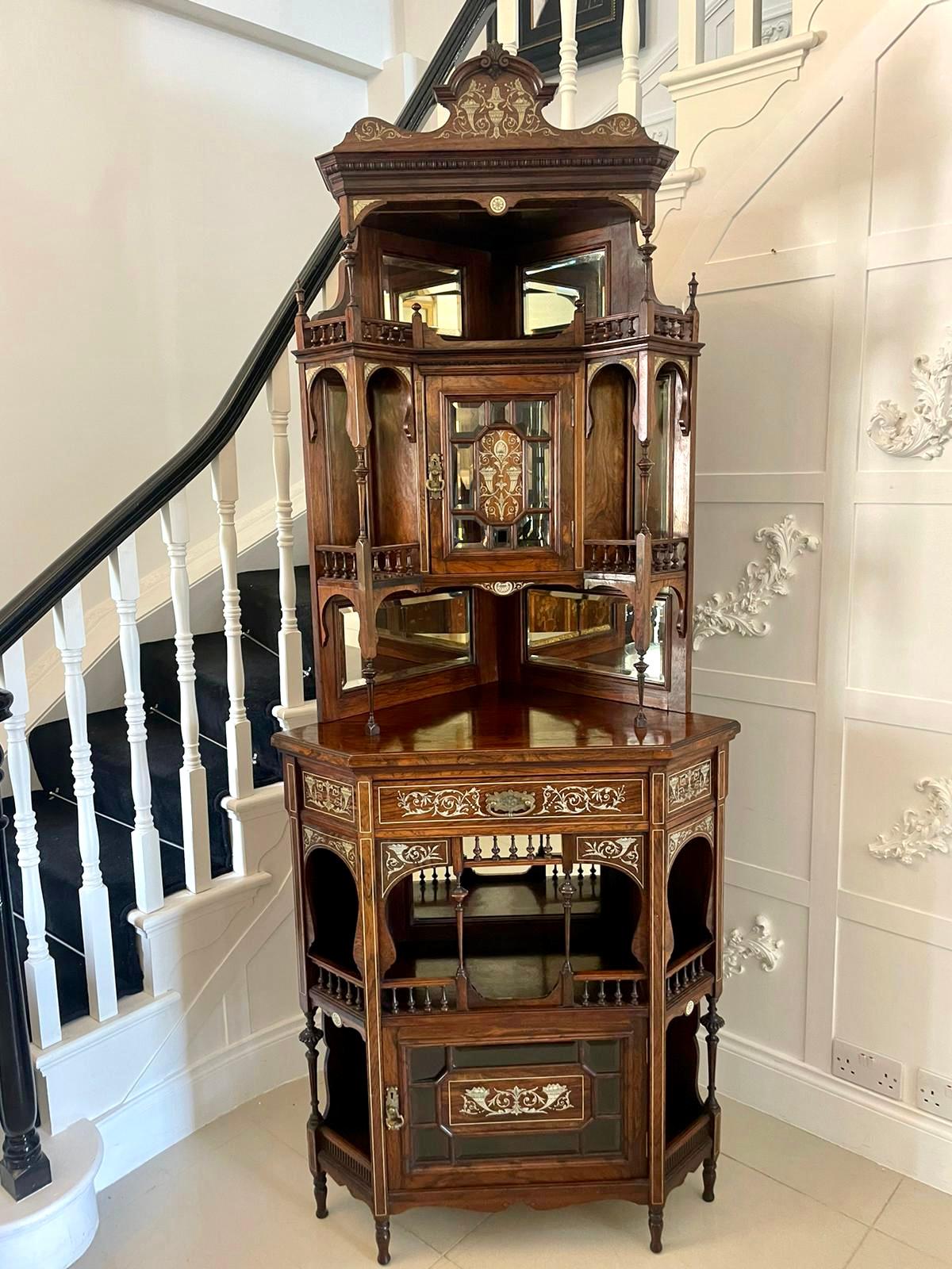 Outstanding quality antique Victorian rosewood inlaid corner cabinet by Maple & Co. having a shaped pediment top,  seven bevelled edge mirrors,  display shelves supported by turned columns,  two single doors to the centre with fantastic inlay,  one