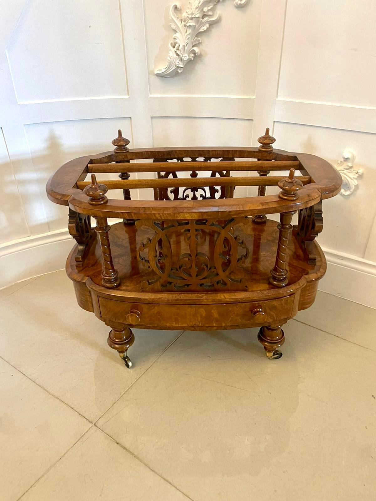 Outstanding quality antique Victorian burr walnut freestanding Canterbury having an outstanding quality burr walnut shaped top with carved finials supported by solid walnut fret carved sides and dividers, one drawer to the base with original turned