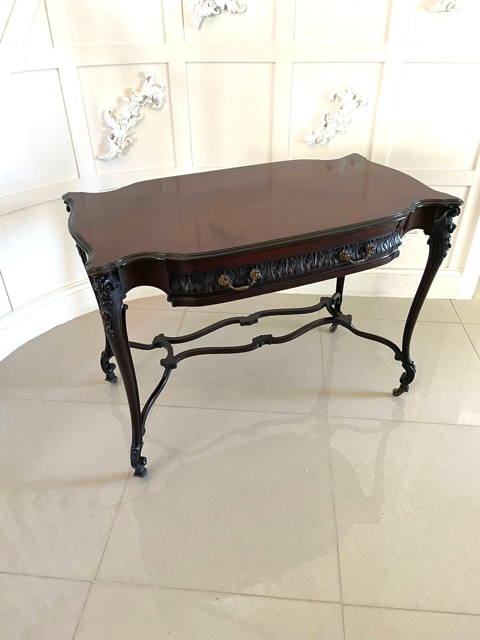 Outstanding quality antique Victorian carved mahogany freestanding centre table having a quality shaped mahogany top with a moulded edge above one long drawer with fantastic quality carving and original brass handles, freestanding carved back and